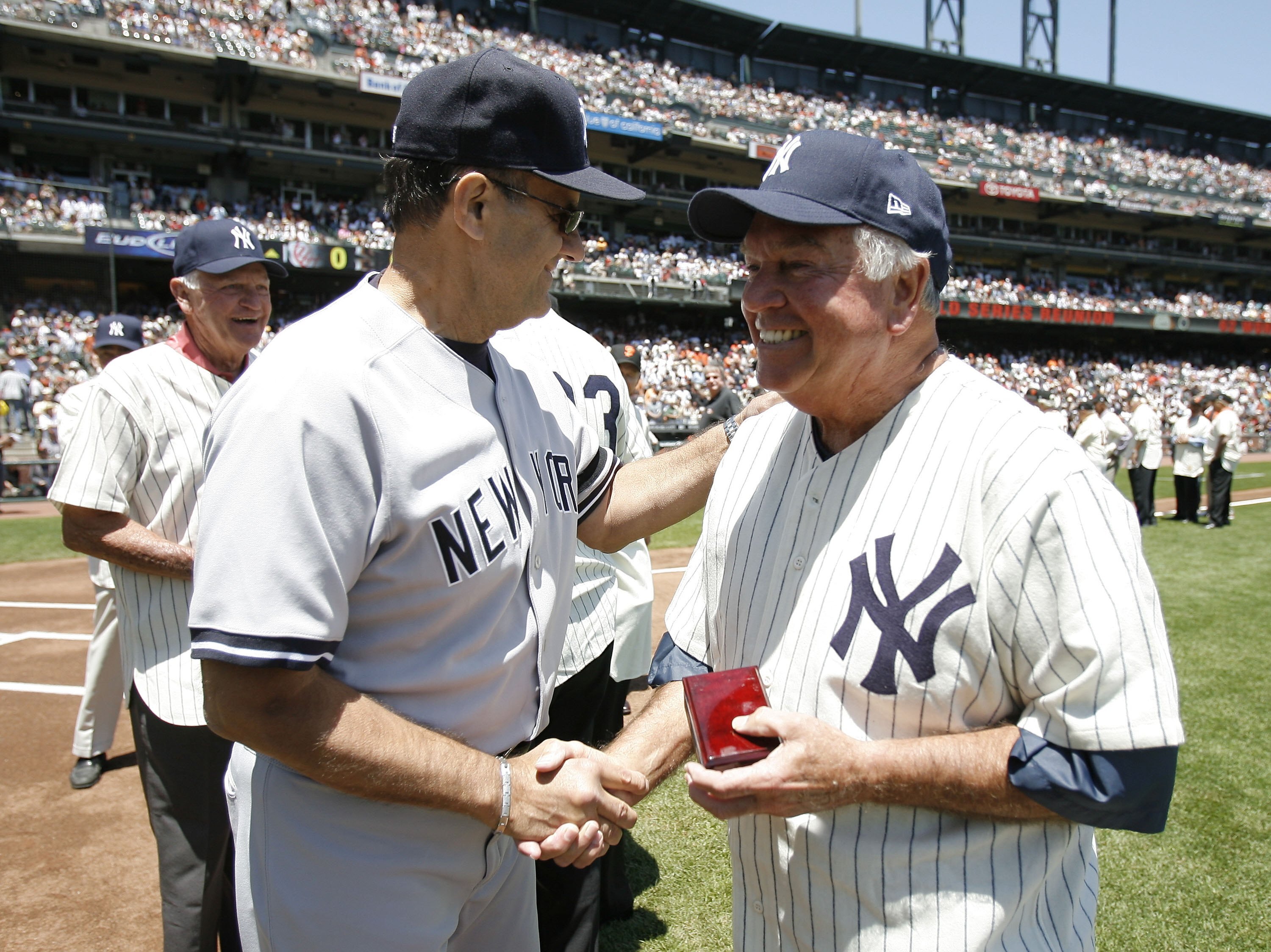SAN FRANCISCO - JUNE 24: Manager Joe Torre #6 of the New York Yankees greets 1962 World Series hero Bobby Richardson of the New York Yankees at a ceremony honoring players from that World Series prior to a game against the San Francisco Giants during a Ma