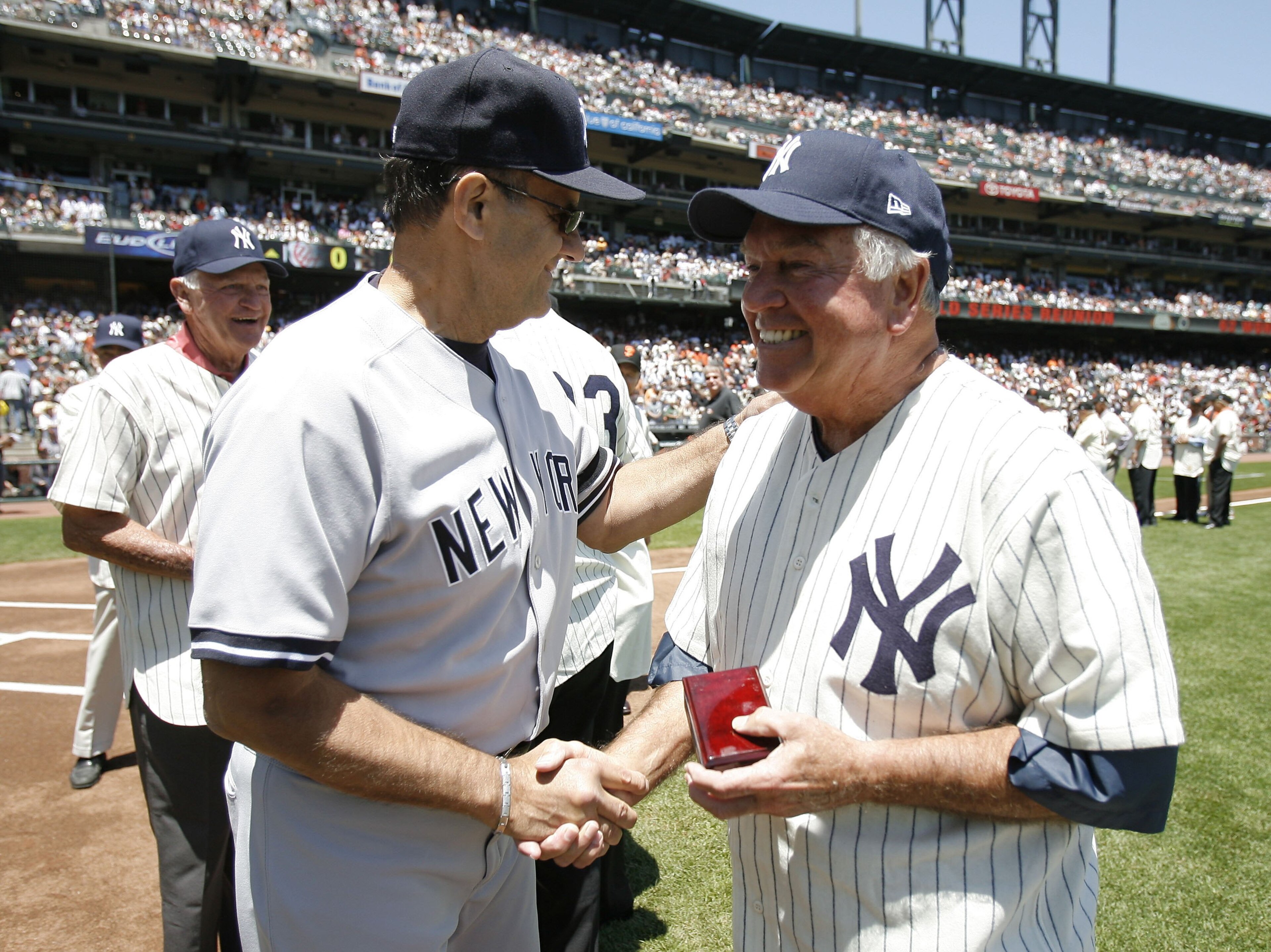 SAN FRANCISCO - JUNE 24: Manager Joe Torre #6 of the New York Yankees greets 1962 World Series hero Bobby Richardson of the New York Yankees at a ceremony honoring players from that World Series prior to a game against the San Francisco Giants during a Ma