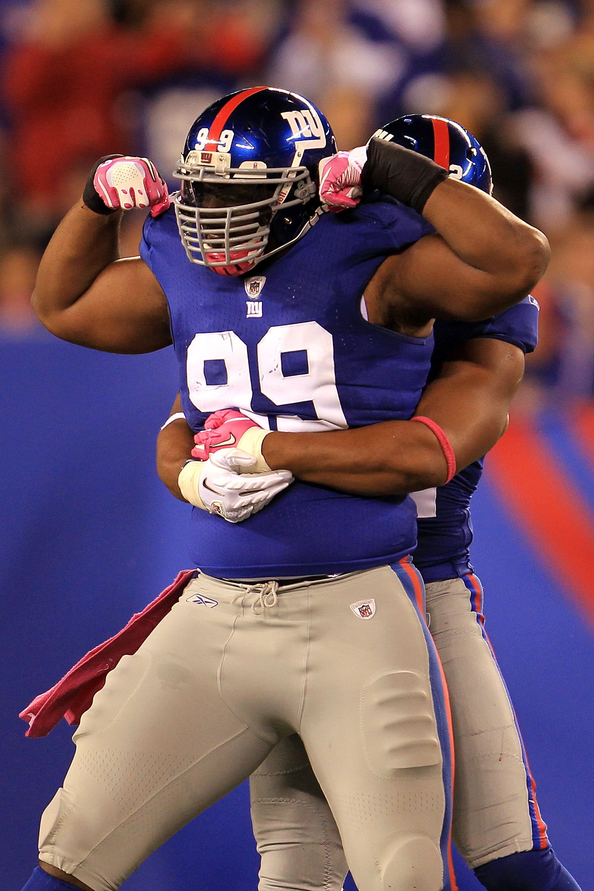 EAST RUTHERFORD, NJ - OCTOBER 03:   Chris Canty #99 of the New York Giants celebrates after a sack against Jay Cutler #6 of the Chicago Bears with teammate Osi Umenyiora #72 at New Meadowlands Stadium on October 3, 2010 in East Rutherford, New Jersey.  (P