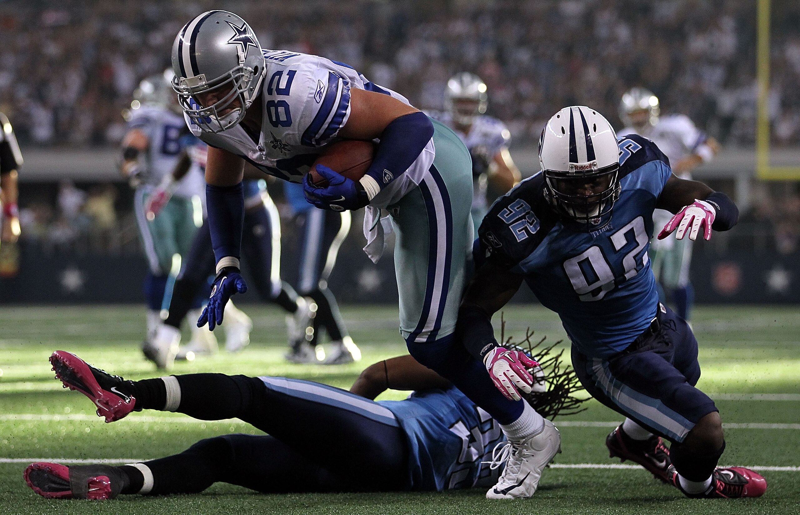 ARLINGTON, TX - OCTOBER 10:  Wide receiver Jason Witten #82 of the Dallas Cowboys runs for a touchdown against Michael Griffin #33 and Will Witherspoon #92 of the Tennessee Titans at Cowboys Stadium on October 10, 2010 in Arlington, Texas.  (Photo by Rona