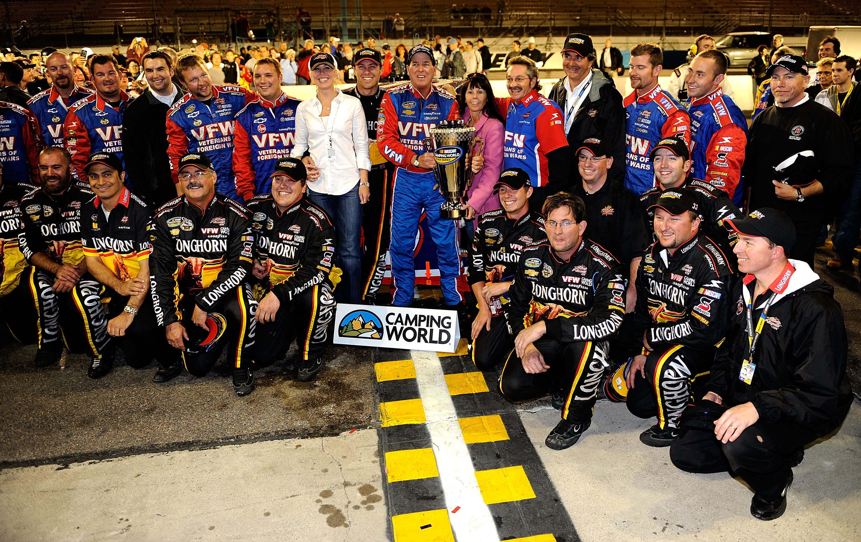 AVONDALE, AZ - NOVEMBER 13:  Ron Hornaday Jr. (C), driver of the #33 VFW.org Chevrolet, celebrates with the series championship trophy and Kevin Harvick Inc. team members after clinching the title with a fourth place finish in the NASCAR Camping World Tru