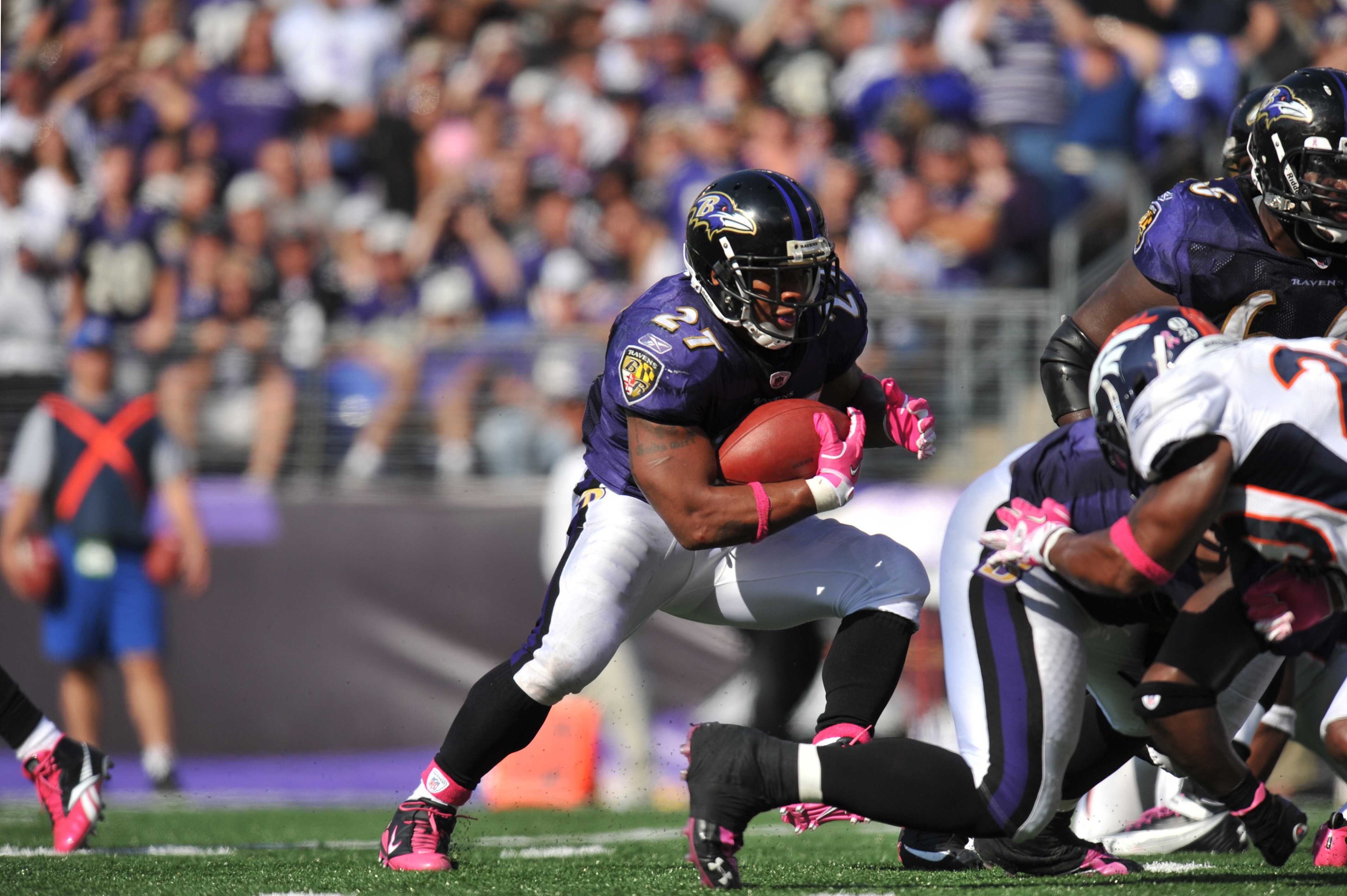 BALTIMORE, MD - OCTOBER 10: Ray Rice #27 of the Baltimore Ravens runs the ball against the Denver Broncos at M&T Bank Stadium on October 10, 2010 in Baltimore, Maryland. Players wore pink in recognition of Breast Cancer Awareness Month. The Ravens defeate