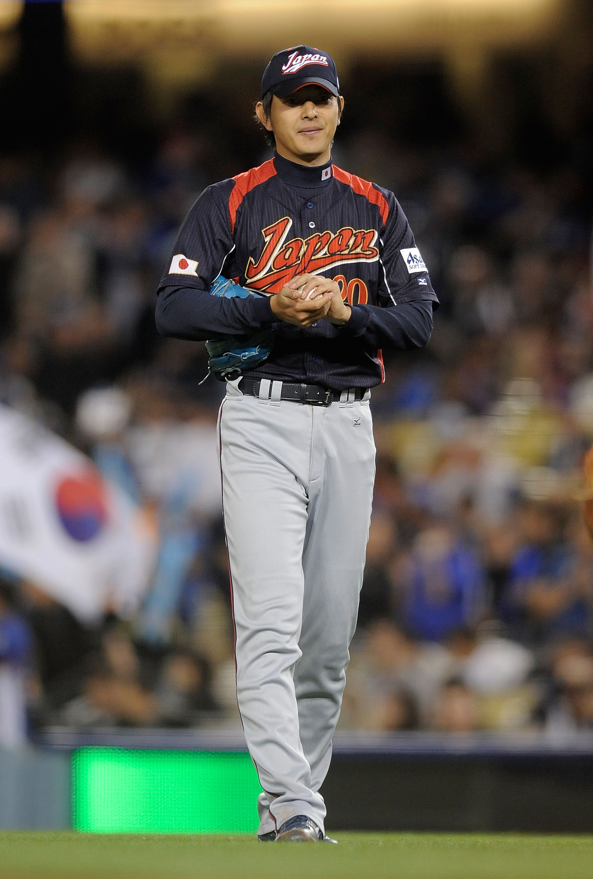 LOS ANGELES, CA - MARCH 23:  Starting pitcher Hisashi Iwakuma #20 of Japan reacts to giving up his first hit of the game in the fourth inning in the finals of the 2009 World Baseball Classic against Korea on March 23, 2009 at Dodger Stadium in Los Angeles