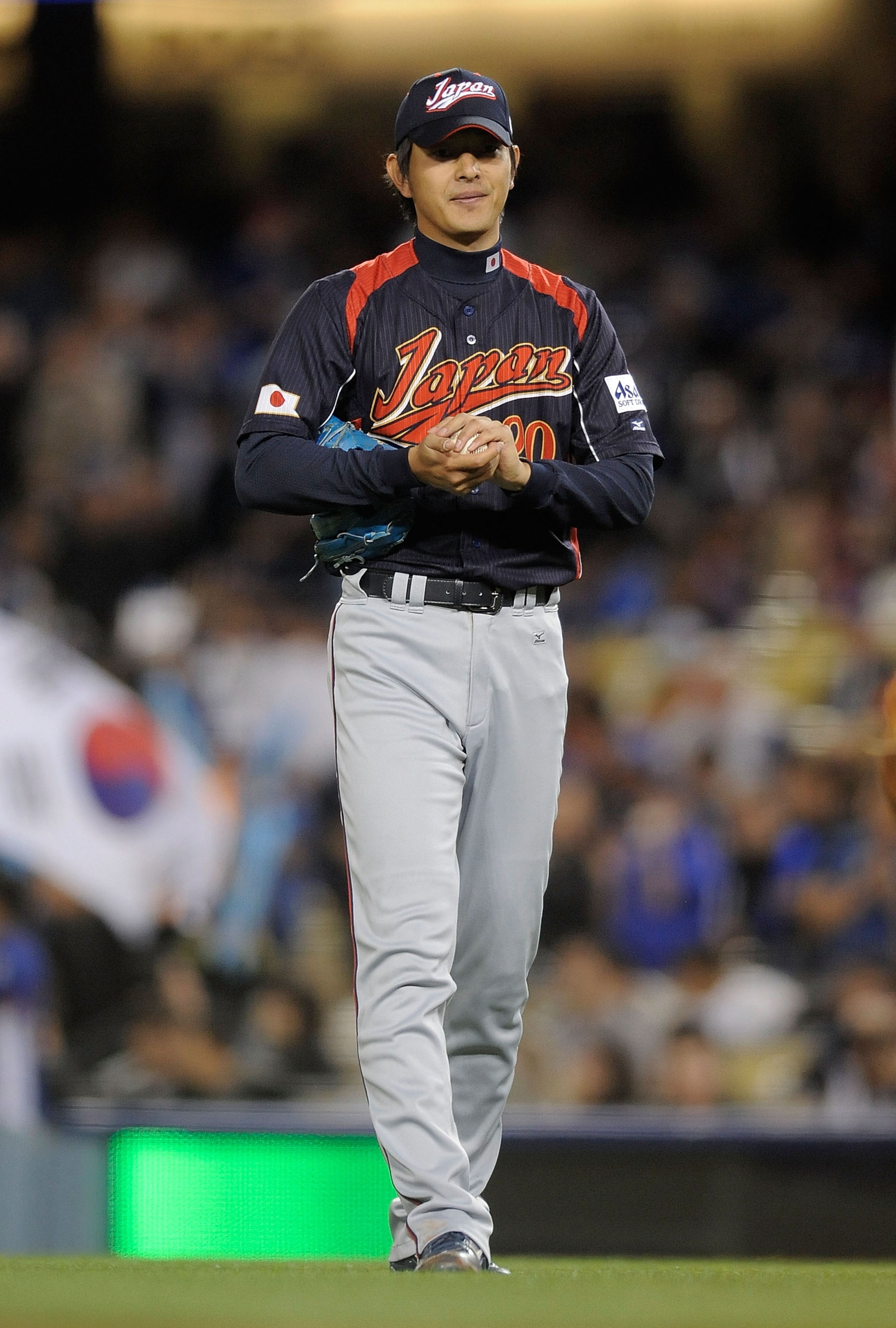 LOS ANGELES, CA - MARCH 23:  Starting pitcher Hisashi Iwakuma #20 of Japan reacts to giving up his first hit of the game in the fourth inning in the finals of the 2009 World Baseball Classic against Korea on March 23, 2009 at Dodger Stadium in Los Angeles