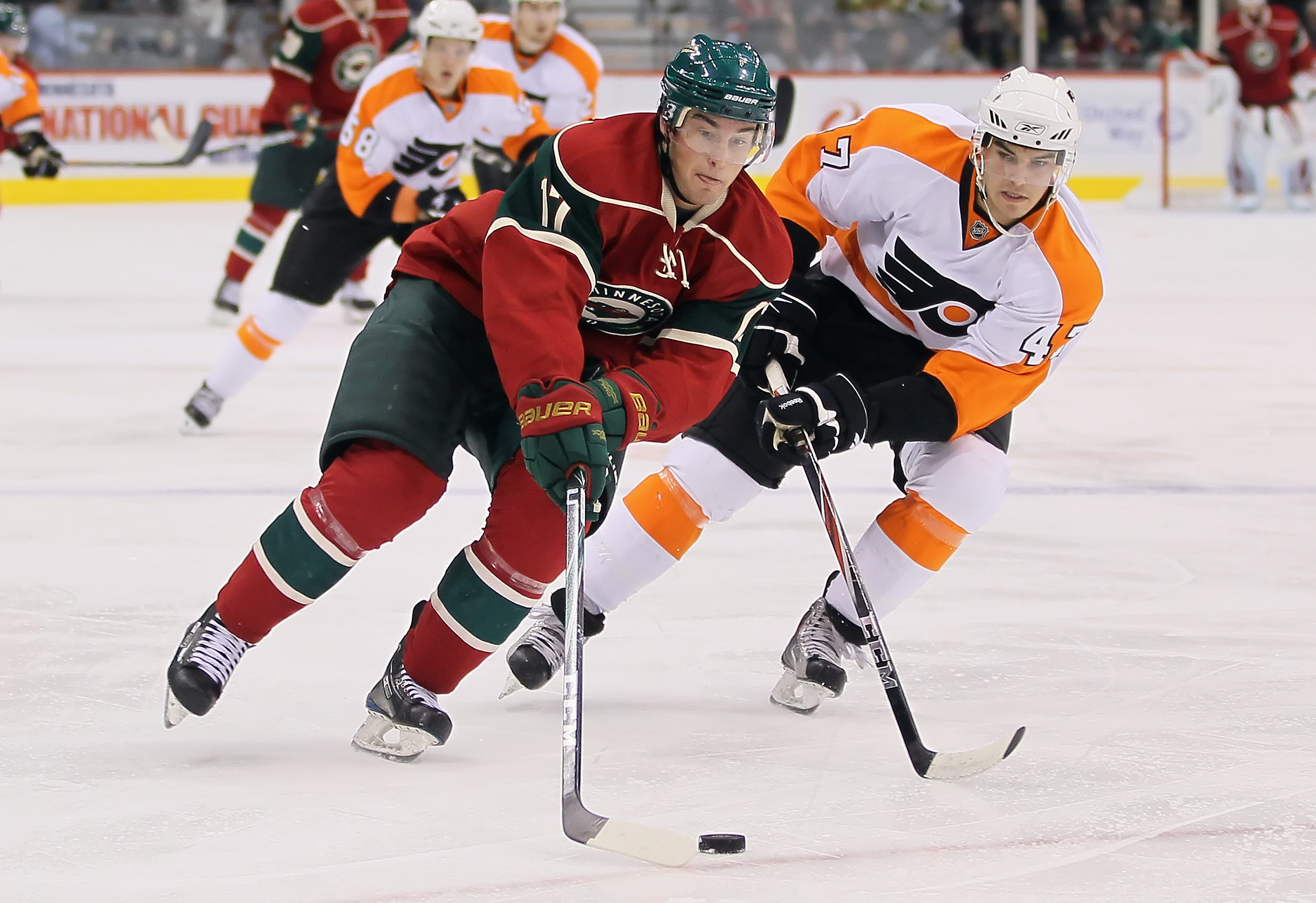 ST PAUL, MN - SEPTEMBER 25:  Casey Wellman #17 of the Minnesota Wild skates around Eric Wellwood#19 of the Philadelphia Flyers during the third period at Xcel Energy Center on September 25, 2010 in St Paul, Minnesota. The Flyers defeated the Wild 3-2 in a