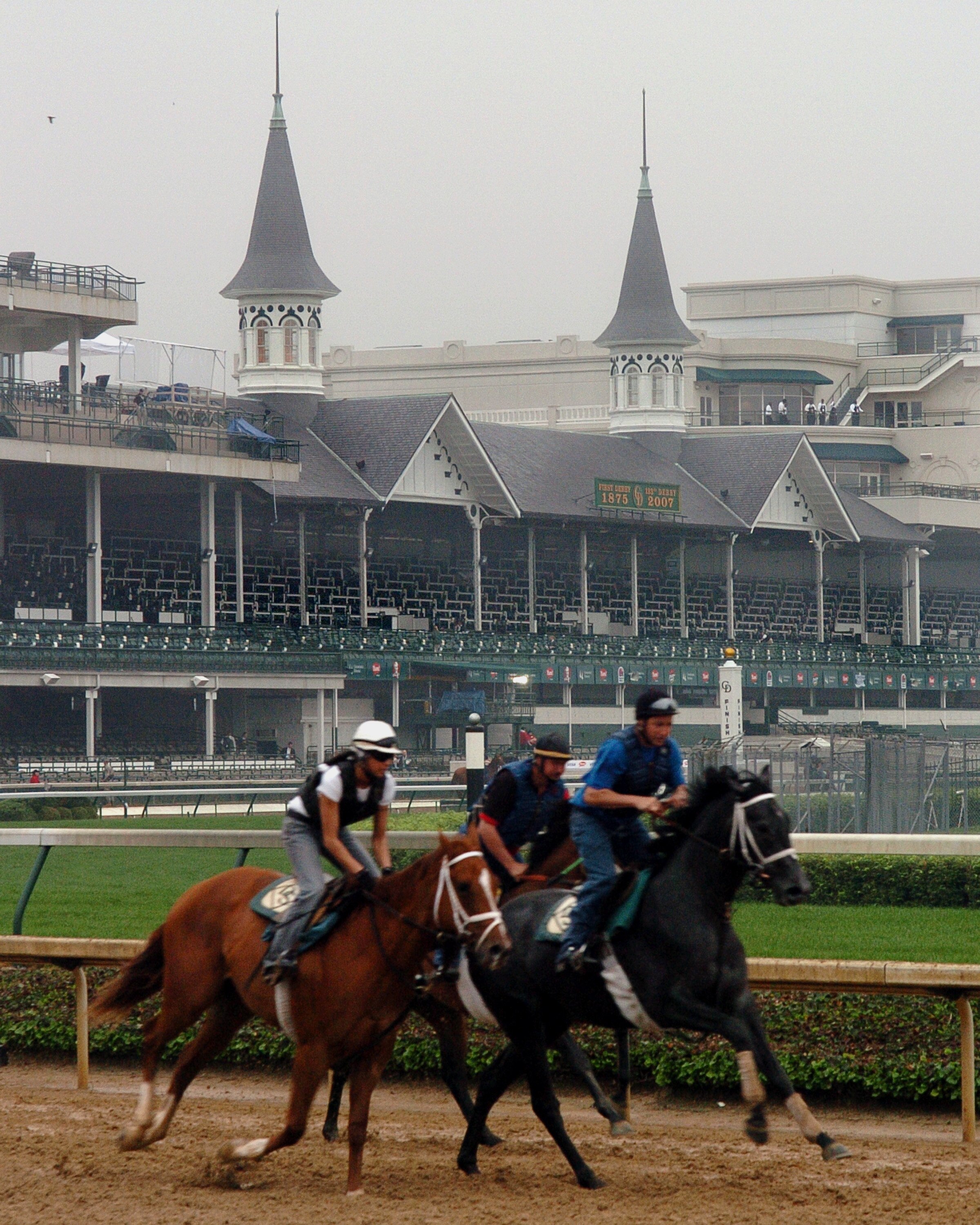 With the famous twin spires as a backdrop, a horses and riders work out before racing  at Churchill Downs May 4, 2007 in Louisville. (Photo by A. Messerschmidt/Getty Images) *** Local Caption ***