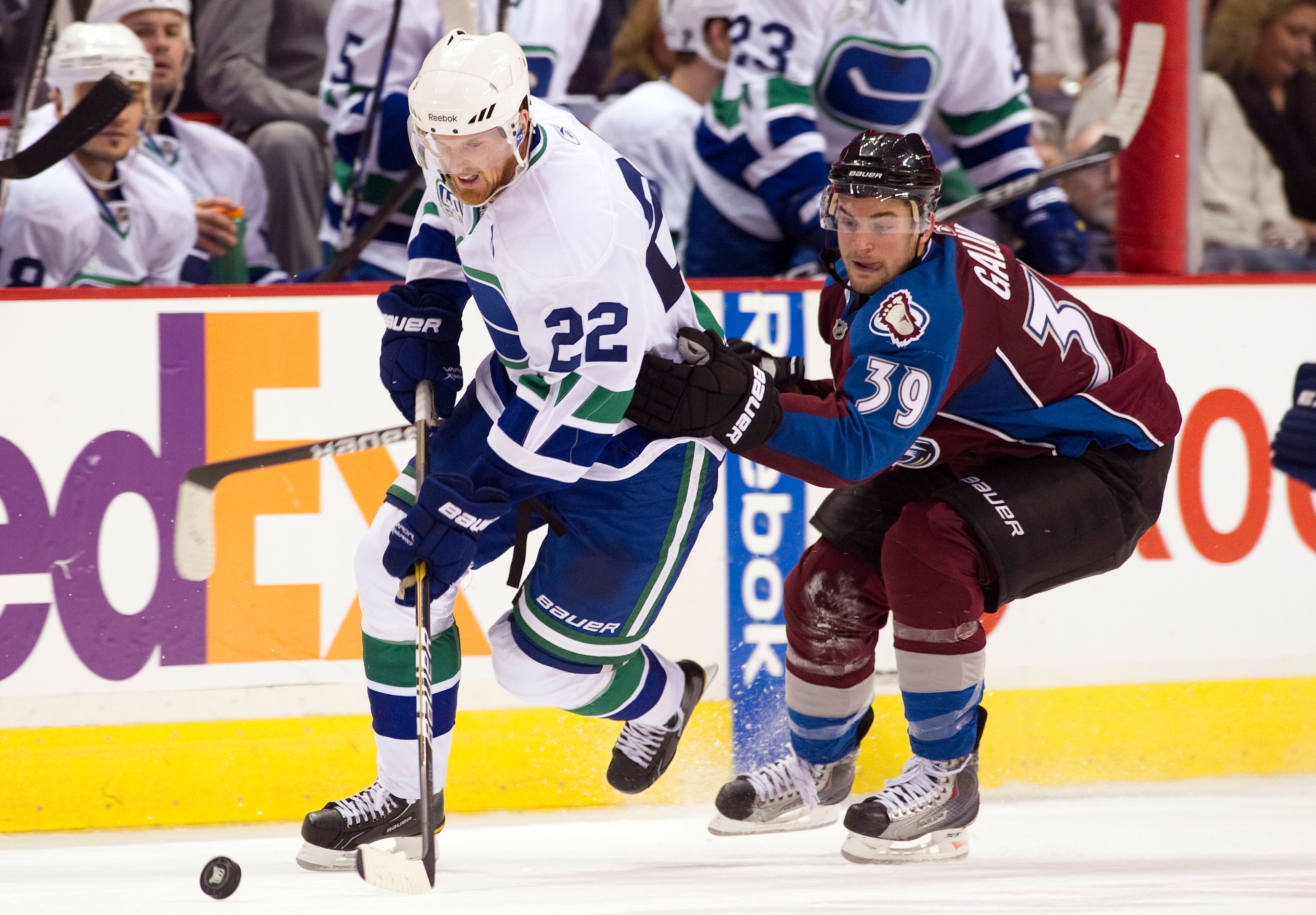 VANCOUVER, CANADA - OCTOBER 26: Daniel Sedin #22 of the Vancouver Canucks tries to break away from TJ Galiardi #39 of the Colorado Avalanche during the third period in NHL action on October 26, 2010 at Rogers Arena in Vancouver, British Columbia, Canada.