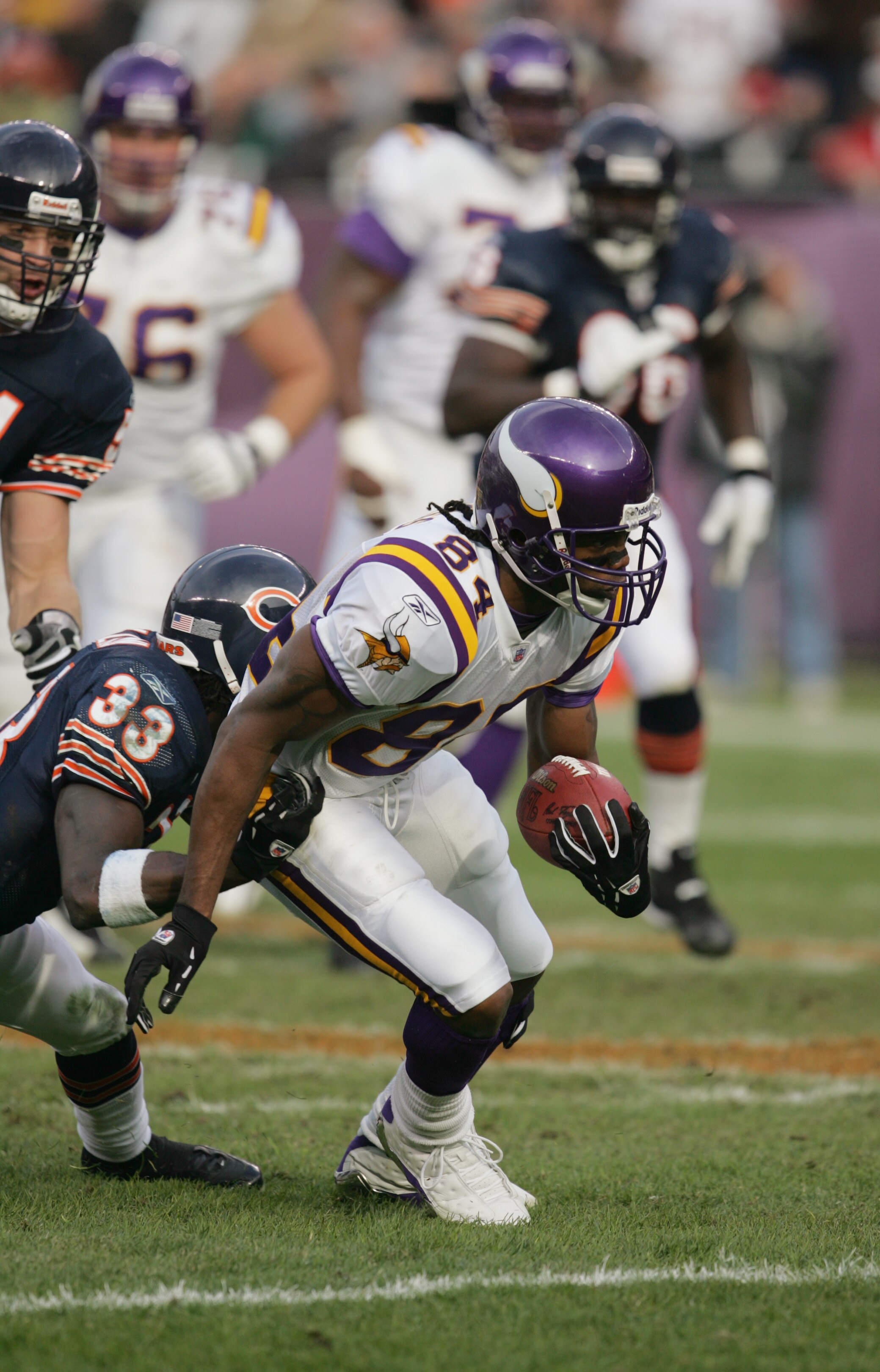 CHICAGO - DECEMBER 5:  Wide receiver Randy Moss #84 of the Minnesota Vikings runs upfield against cornerback Ralph Brown #33 of the Chicago Bears on December 5, 2004 at Soldier Field in Chicago, Illinois. The Bears defeated the Vikings 24-14. (Photo by Jo