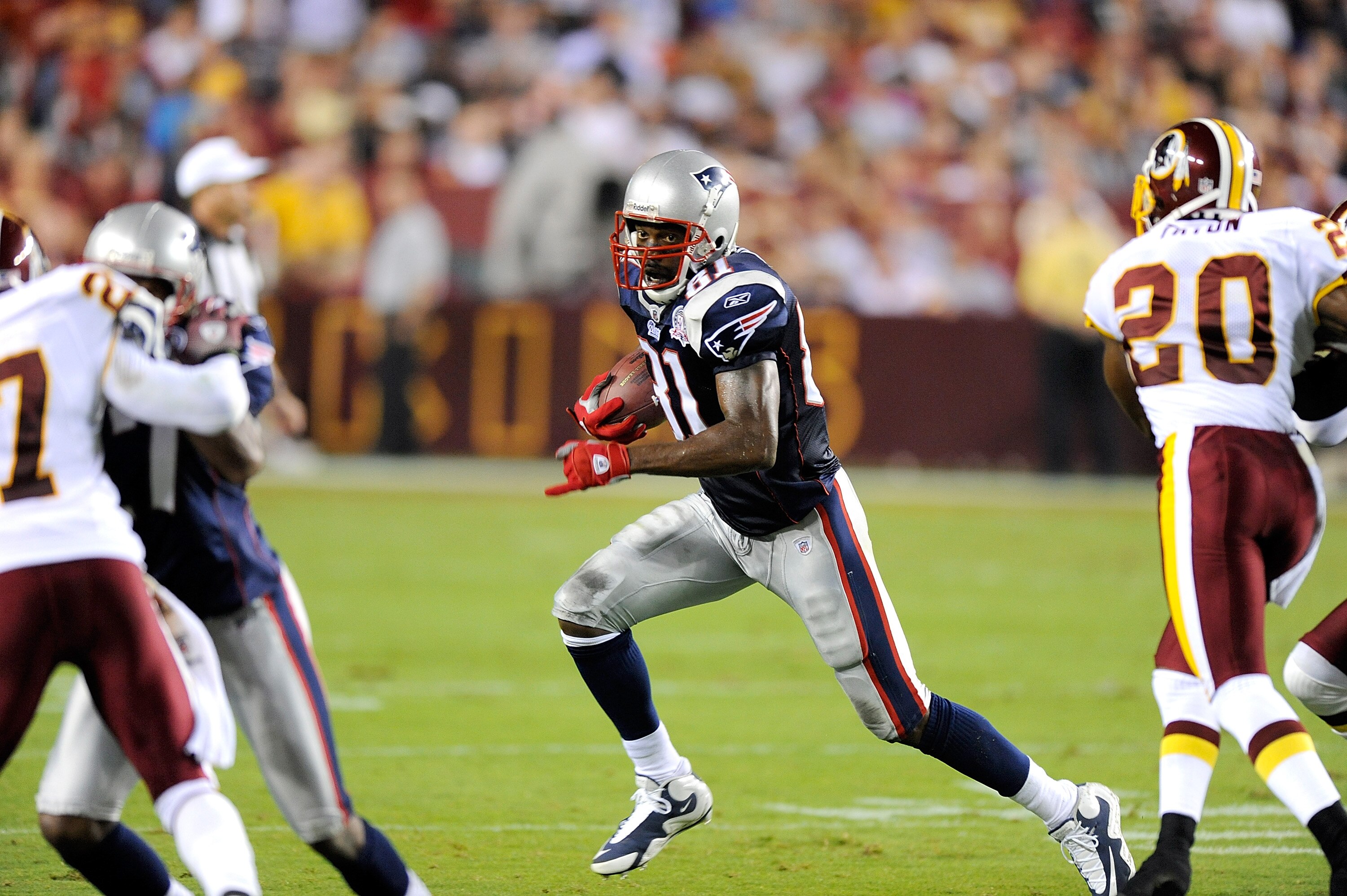 LANDOVER, MD - AUGUST 28:  Randy Moss #81 of the New England Patriots runs with the ball after catching a pass during a preseason game against the Washington Redskins at FedExField on August 28, 2009 in Landover, Maryland.  (Photo by Greg Fiume/Getty Imag