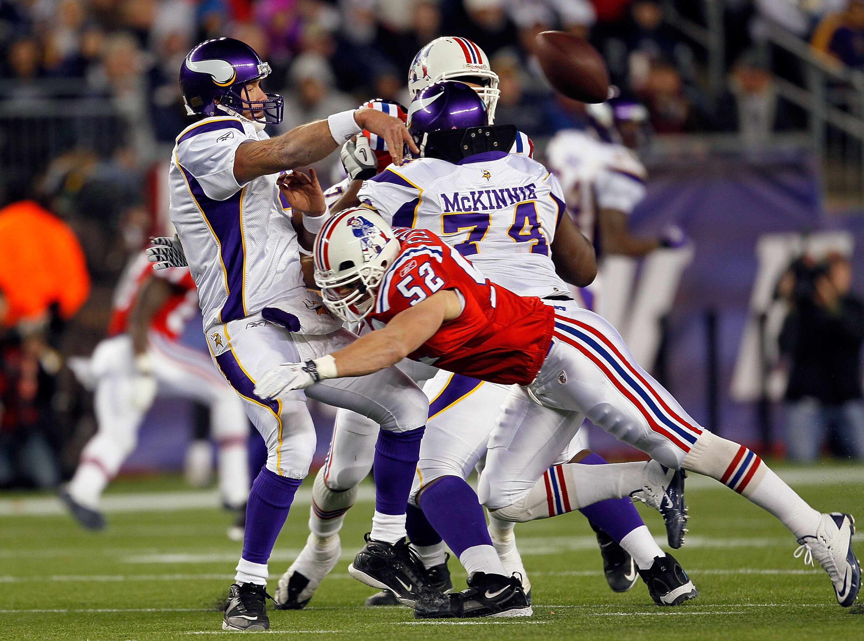 FOXBORO, MA - OCTOBER 31:  Brett Favre #4 of the Minnesota Vikings throws the ball but is hit by Dane Fletcher #52 of the New England Patriots in the fourth quarter at Gillette Stadium on October 31, 2010 in Foxboro, Massachusetts. Favre was injured on th