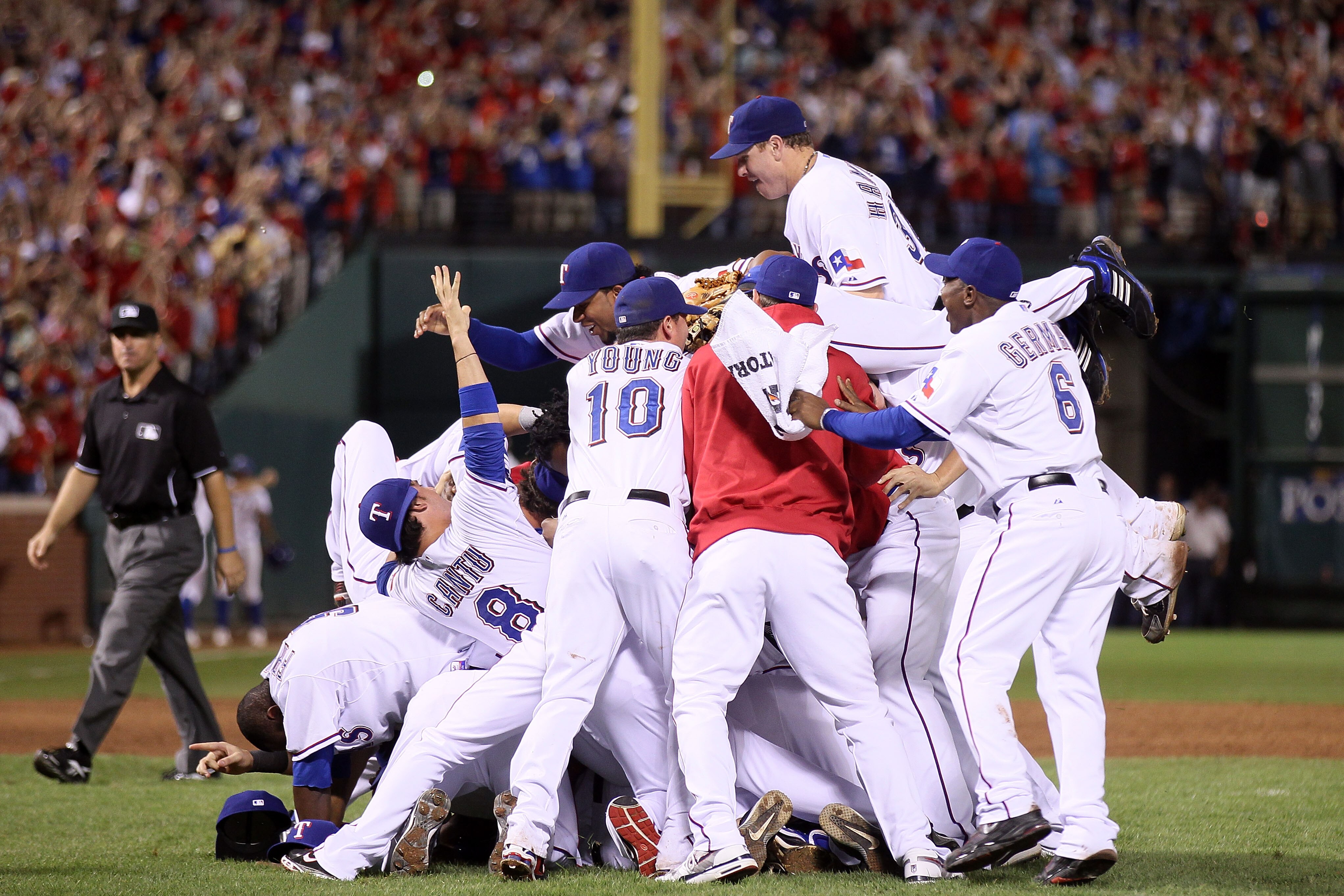ARLINGTON, TX - OCTOBER 22:  Josh Hamilton #32 of the Texas Rangers dives on the pile as he celebrates with his teammates after the Rangers won 6-1 against the New York Yankees in Game Six of the ALCS during the 2010 MLB Playoffs at Rangers Ballpark in Ar