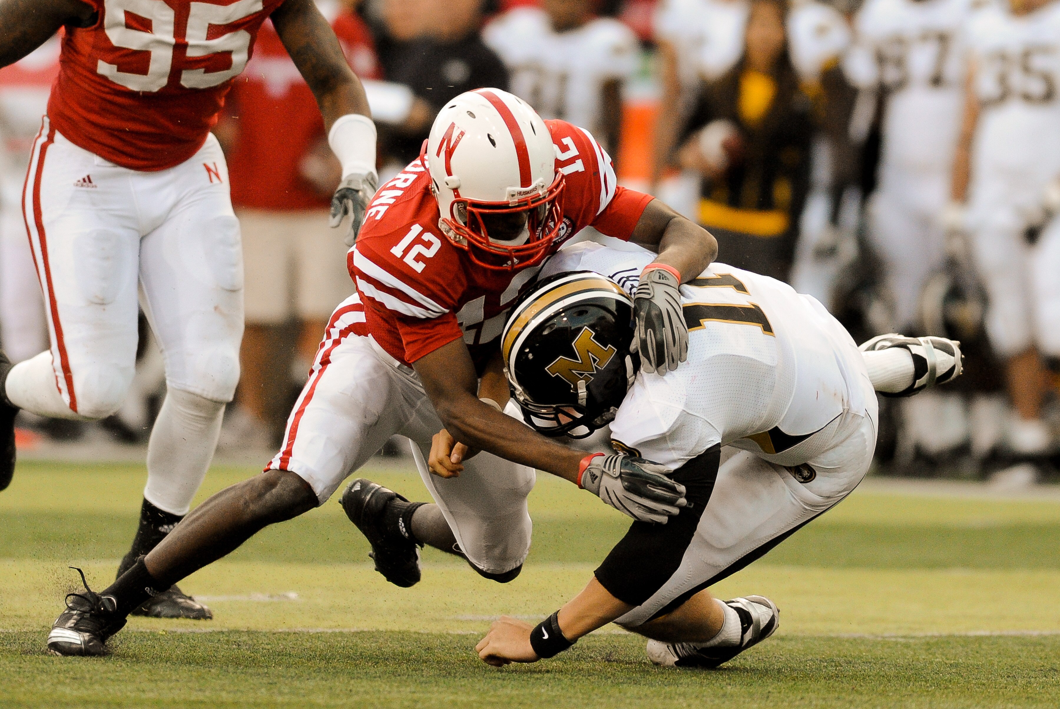 LINCOLN, NE - OCTOBER 30: Safety Courtney Osborne #12 of the Nebraska Cornhuskers hits  quarterback Blaine Gabbert #11 of the Missouri Tigers during second half action of their game at Memorial Stadium on October 30, 2010 in Lincoln, Nebraska. Nebraska De