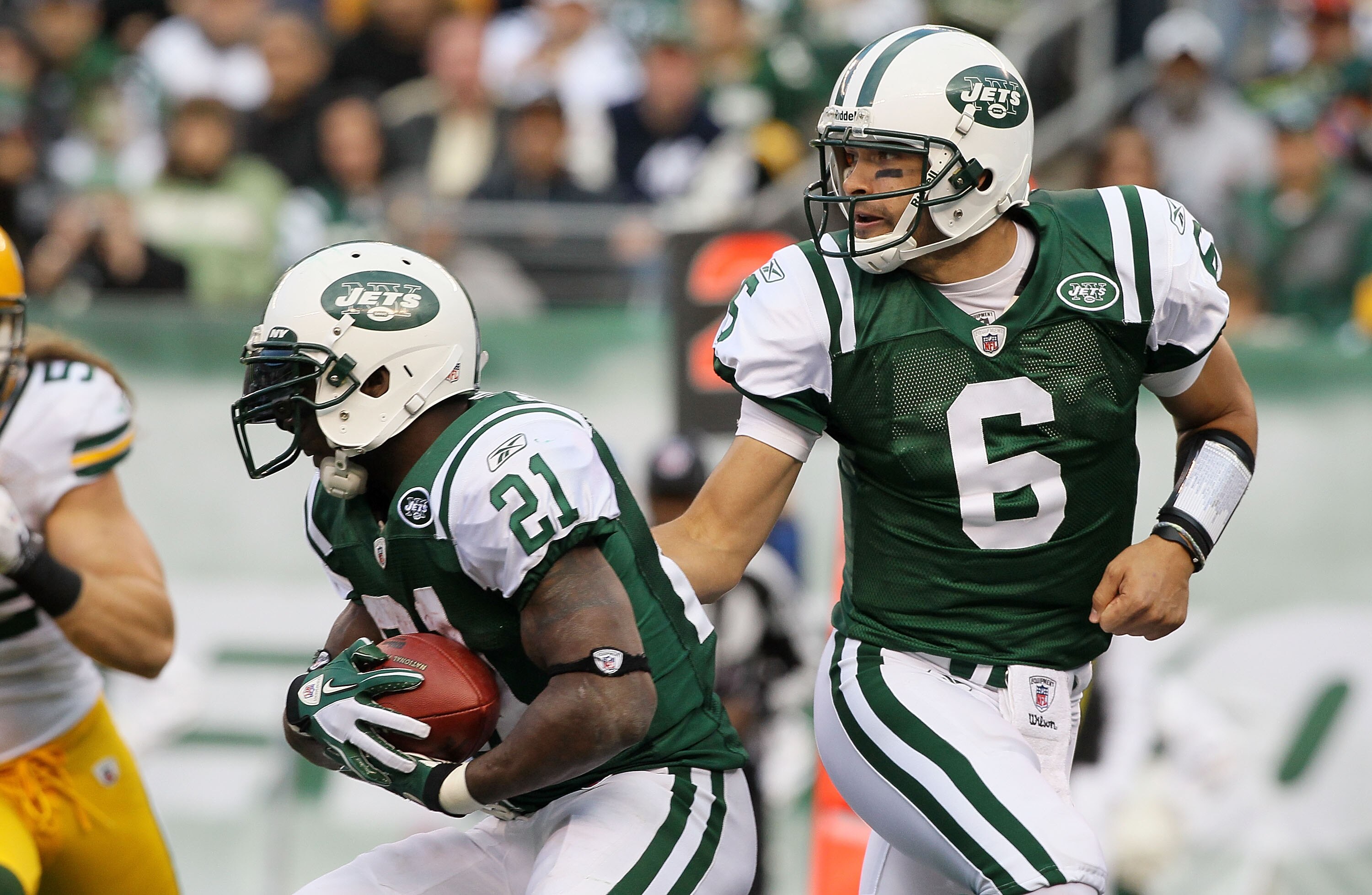 EAST RUTHERFORD, NJ - OCTOBER 31: Mark Sanchez #6 of the New York Jets hands the ball to teammate LaDainian Tomlinson #21 against the Green Bay Packers on October 31, 2010 at the New Meadowlands Stadium in East Rutherford, New Jersey. The Packers defeated