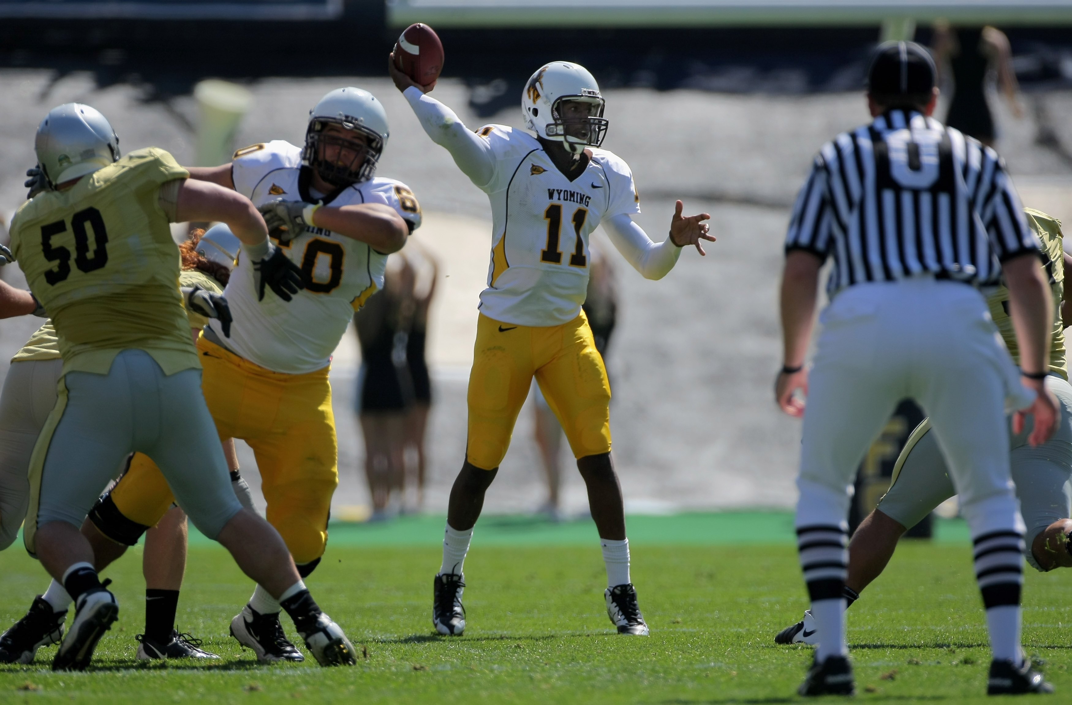 BOULDER, CO - SEPTEMBER 19:  Quarterback Robert Benjamin #11 of the Wyoming Cowboys delivers a pass against the Colorado Buffaloes at Folsom Field on September 19, 2009 in Boulder, Colorado. The Buffaloes defeated the Cowboys 24-0.  (Photo by Doug Pensing