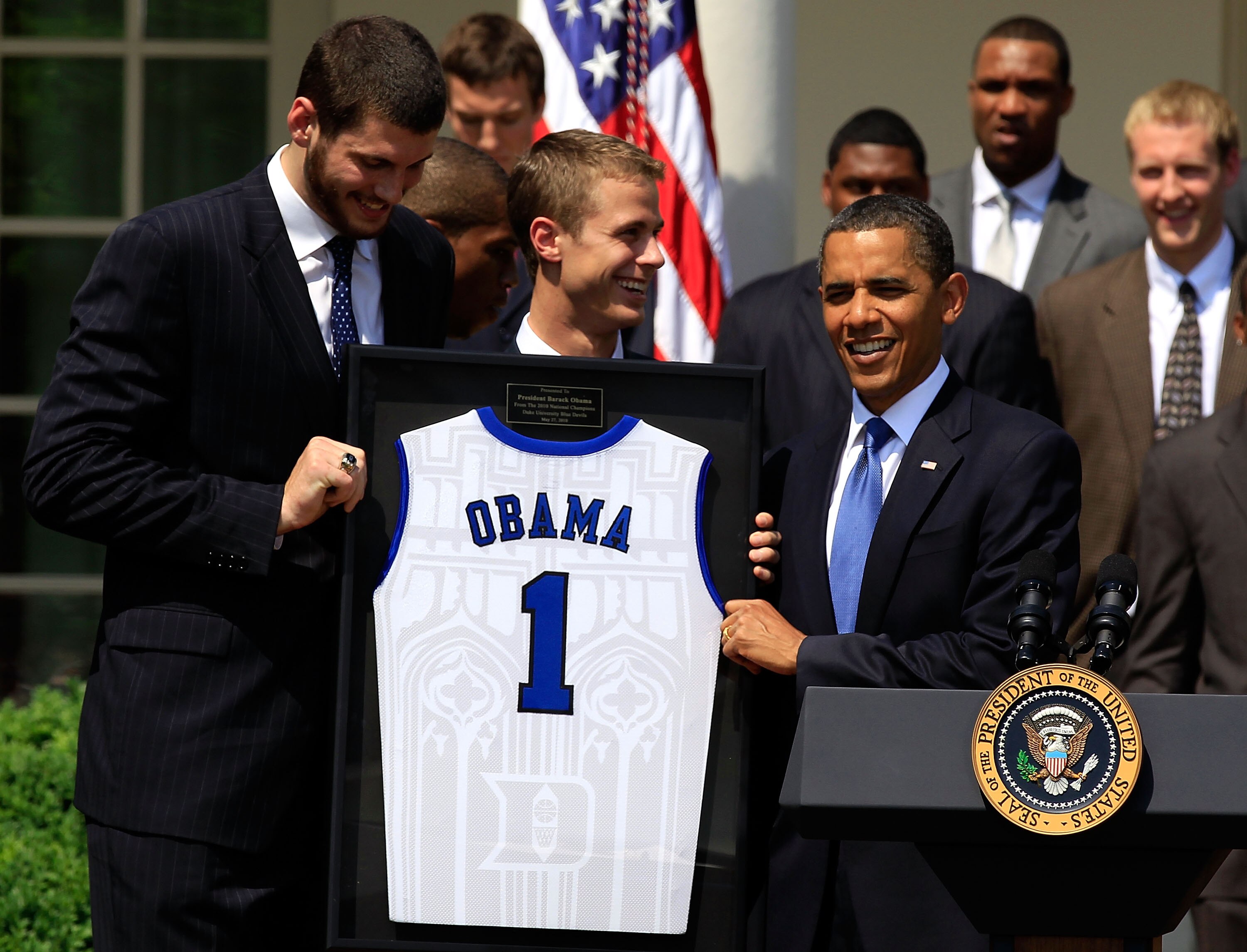 WASHINGTON - MAY 27:  U.S. President Barack Obama (R) receives a jersey from players Brian Zoubek (L) and Jon Scheyer (2nd L) of the Duke Blue Devils during a Rose Garden event May 27, 2010 at the White House in Washington, DC. Obama hosted the NCAA men b