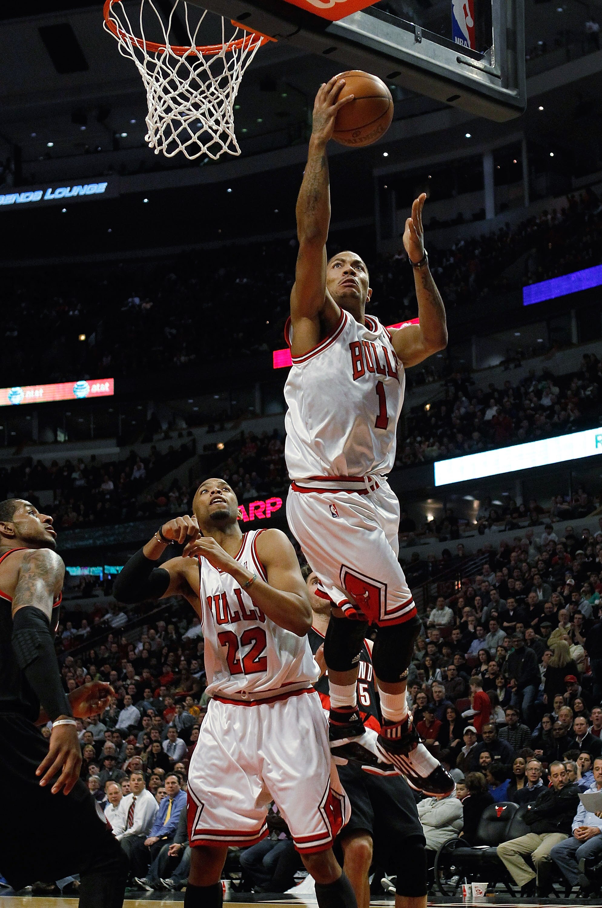 CHICAGO - FEBRUARY 26: Derrick Rose #1 of the Chicago Bulls goes up for a shot over teammate Taj Gibson #22 on his way to a game-high 33 points against the Portland Trail Blazers at the United Center on February 26, 2010 in Chicago, Illinois. The Bulls de