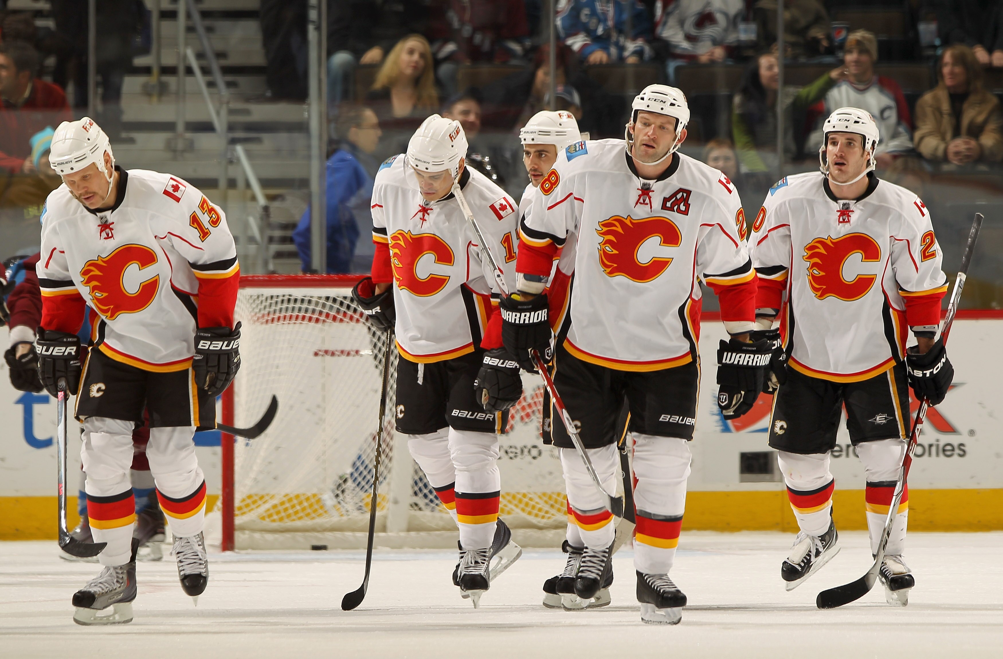 DENVER - NOVEMBER 09:  (L-R) Olli Jokinen #13, Rene Bourque #17, Mark Giordano #5, Robyn Regehr #28 and Curtis Glencross #20 of the Calgary Flames skate toward the bench after scoring against the Colorado Avalanche at the Pepsi Center on November 9, 2010