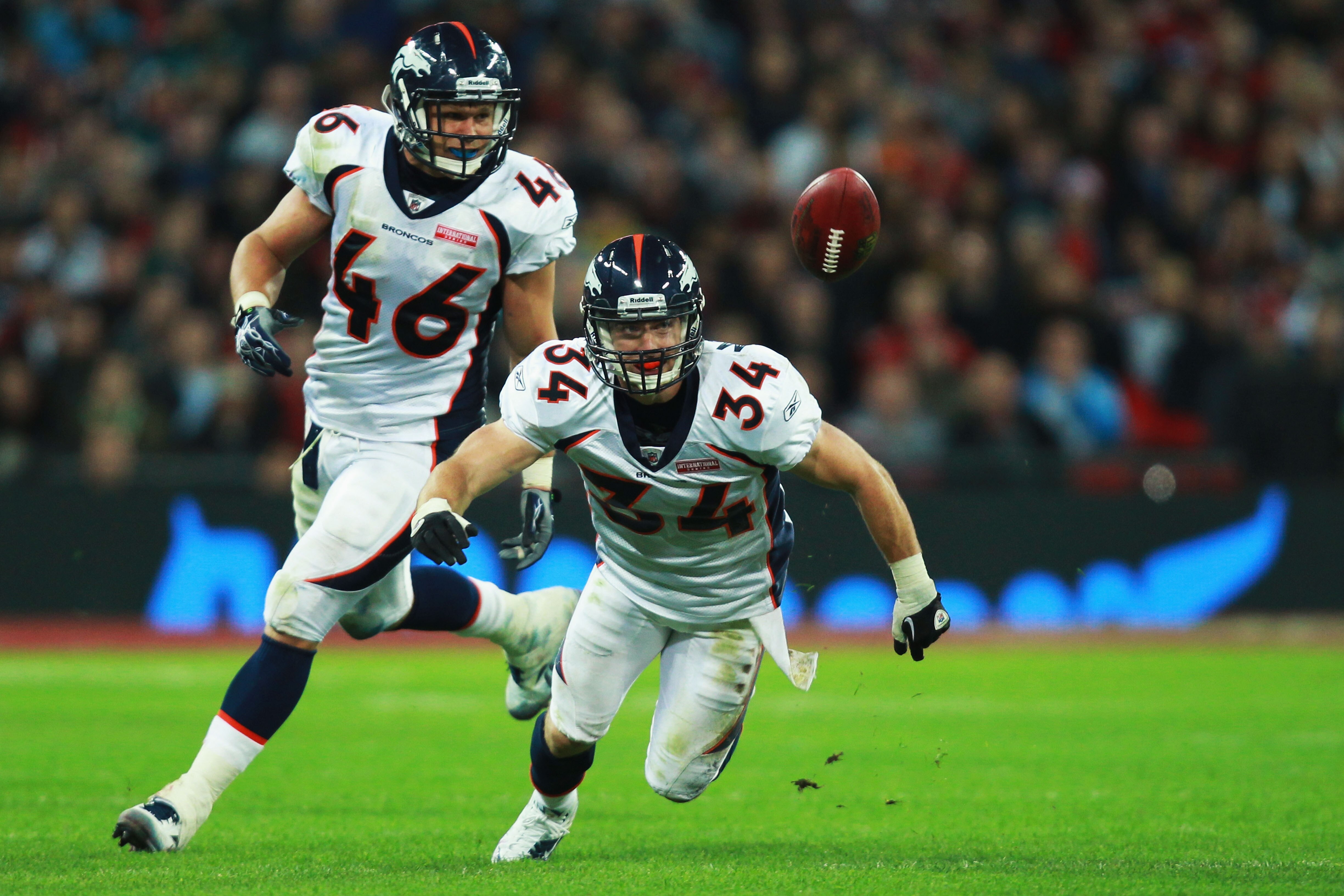 LONDON, ENGLAND - OCTOBER 31:  Kyle McCarthy #34 and Spencer Larsen #46 of Denver Broncos keep their eye on the ball during the NFL International Series match between Denver Broncos and San Francisco 49ers at Wembley Stadium on October 31, 2010 in London,