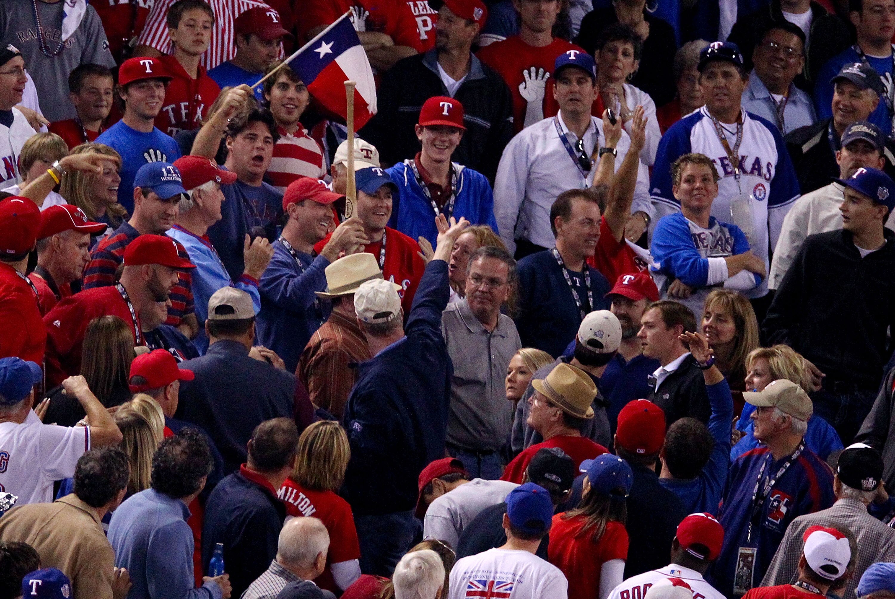 ARLINGTON, TX - NOVEMBER 01:  Fans react after catching a thrown bat by Josh Hamilton #32 of the Texas Rangers while playing against the San Francisco Giants in the sixth inning of Game Five of the 2010 MLB World Series at Rangers Ballpark in Arlington on