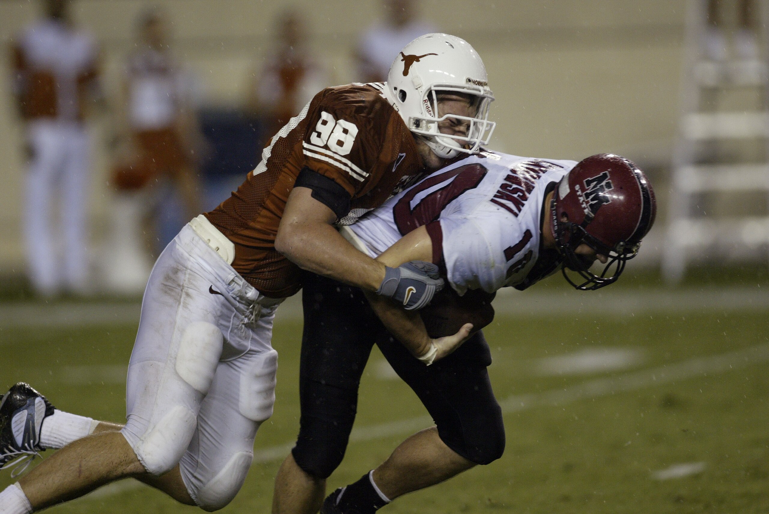 AUSTIN, TX - AUGUST 31:  Defensive end Bryan Pickryl #98 of the University of Texas at Austin Longhorns sacks quarterback Paul Dombrowski #10 of the New Mexico State University Aggies at Texas Memorial Stadium on August 31, 2003 in Austin, Texas. Texas de