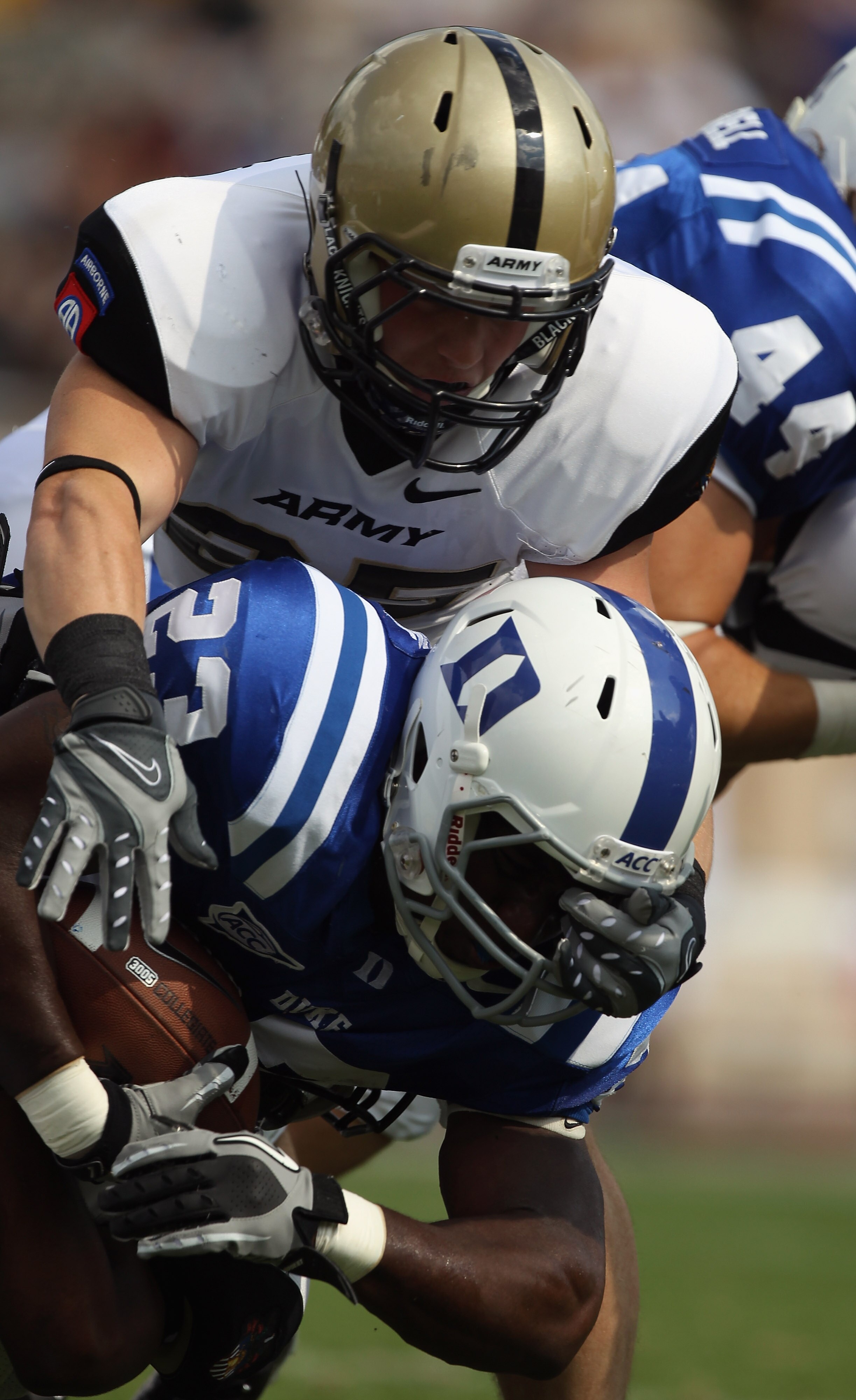 DURHAM, NC - SEPTEMBER 25:  Ty Schrader #25 of the Army Black Knights tackles Juwan Thompson #23 of the Duke Blue Devils at Wallace Wade Stadium on September 25, 2010 in Durham, North Carolina.  (Photo by Streeter Lecka/Getty Images)