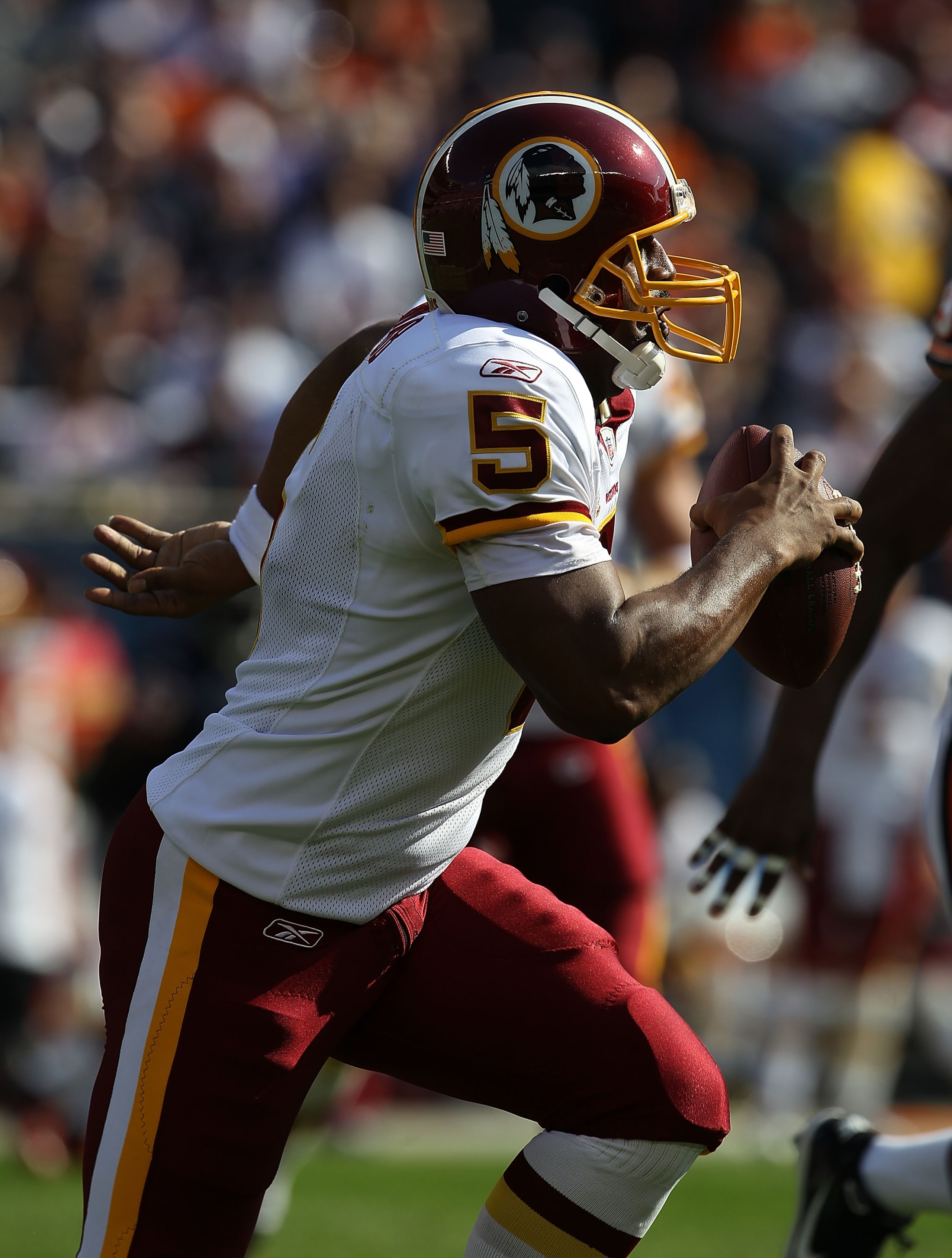 CHICAGO - OCTOBER 24: Donovan McNabb #5 of the Washington Redskins rolls out to look for a receiver against the Chicago Bears at Soldier Field on October 24, 2010 in Chicago, Illinois.  The Redskins defeated the Bears 17-14. (Photo by Jonathan Daniel/Gett