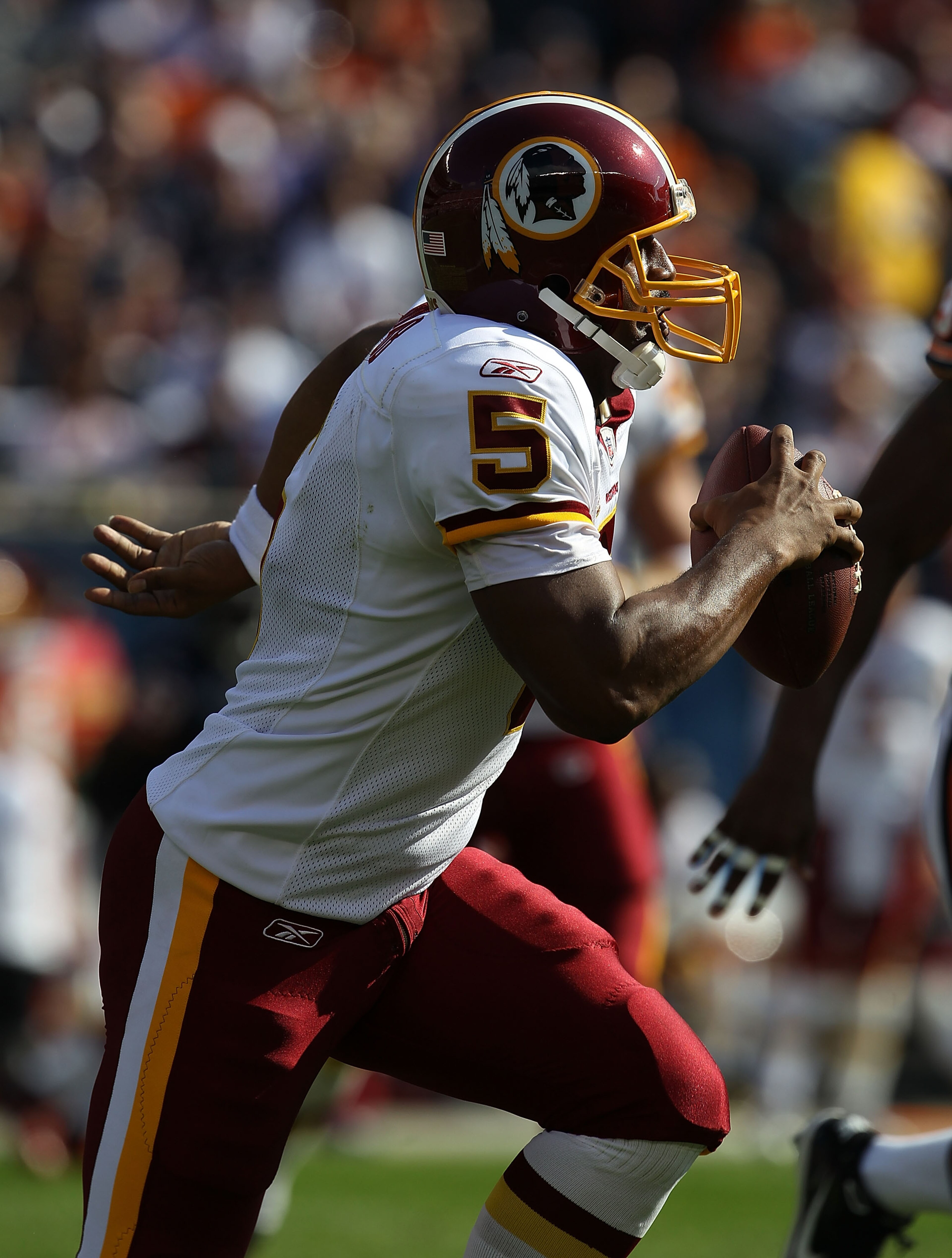 CHICAGO - OCTOBER 24: Donovan McNabb #5 of the Washington Redskins rolls out to look for a receiver against the Chicago Bears at Soldier Field on October 24, 2010 in Chicago, Illinois.  The Redskins defeated the Bears 17-14. (Photo by Jonathan Daniel/Gett