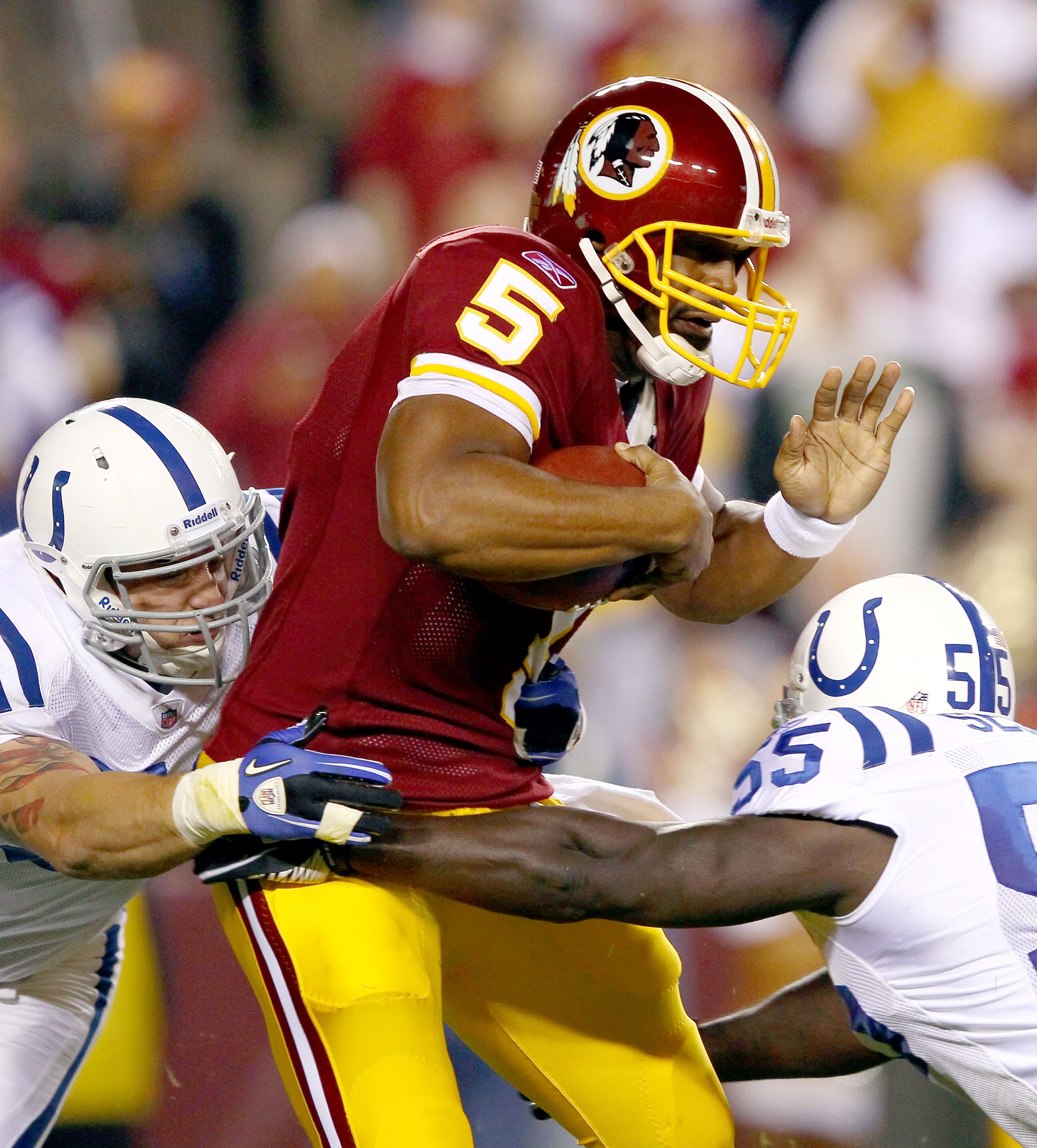 LANDOVER, MD - OCTOBER 17: Quarterback Donovan McNabb #5 of the Washington Redskins is sacked by Clint Session #55 and Pat Angerer #51 of the Indianapolis Colts in first quarter action at FedExField on October 17, 2010 in Landover, Maryland.  (Photo by Wi