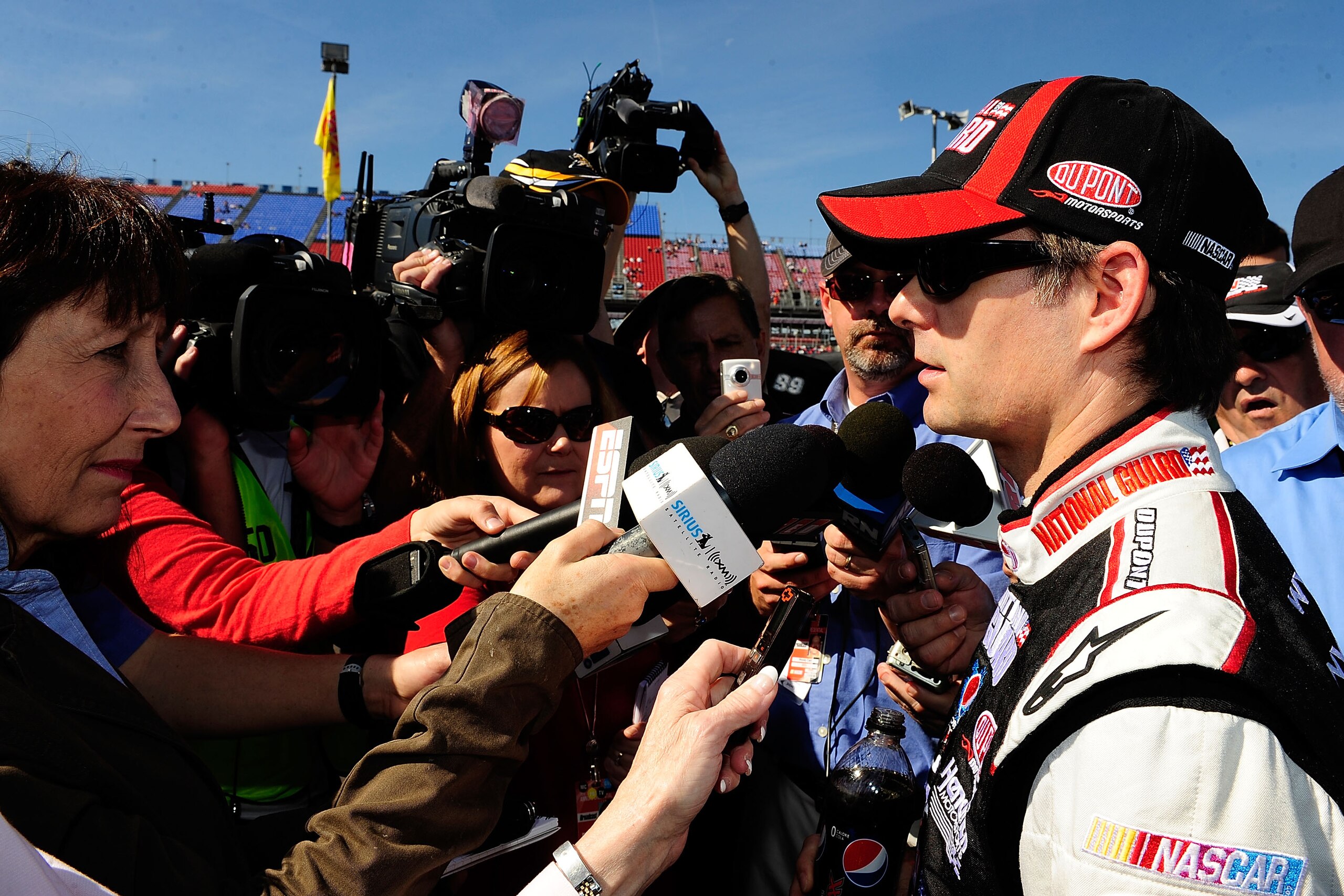 TALLADEGA, AL - OCTOBER 30:  Jeff Gordon (R), driver of the #24 DuPont/National Guard Chevrolet,  speaks to the media after qualifying for the NASCAR Sprint Cup Series AMP Energy Juice 500 at Talladega Superspeedway on October 30, 2010 in Talladega, Alaba