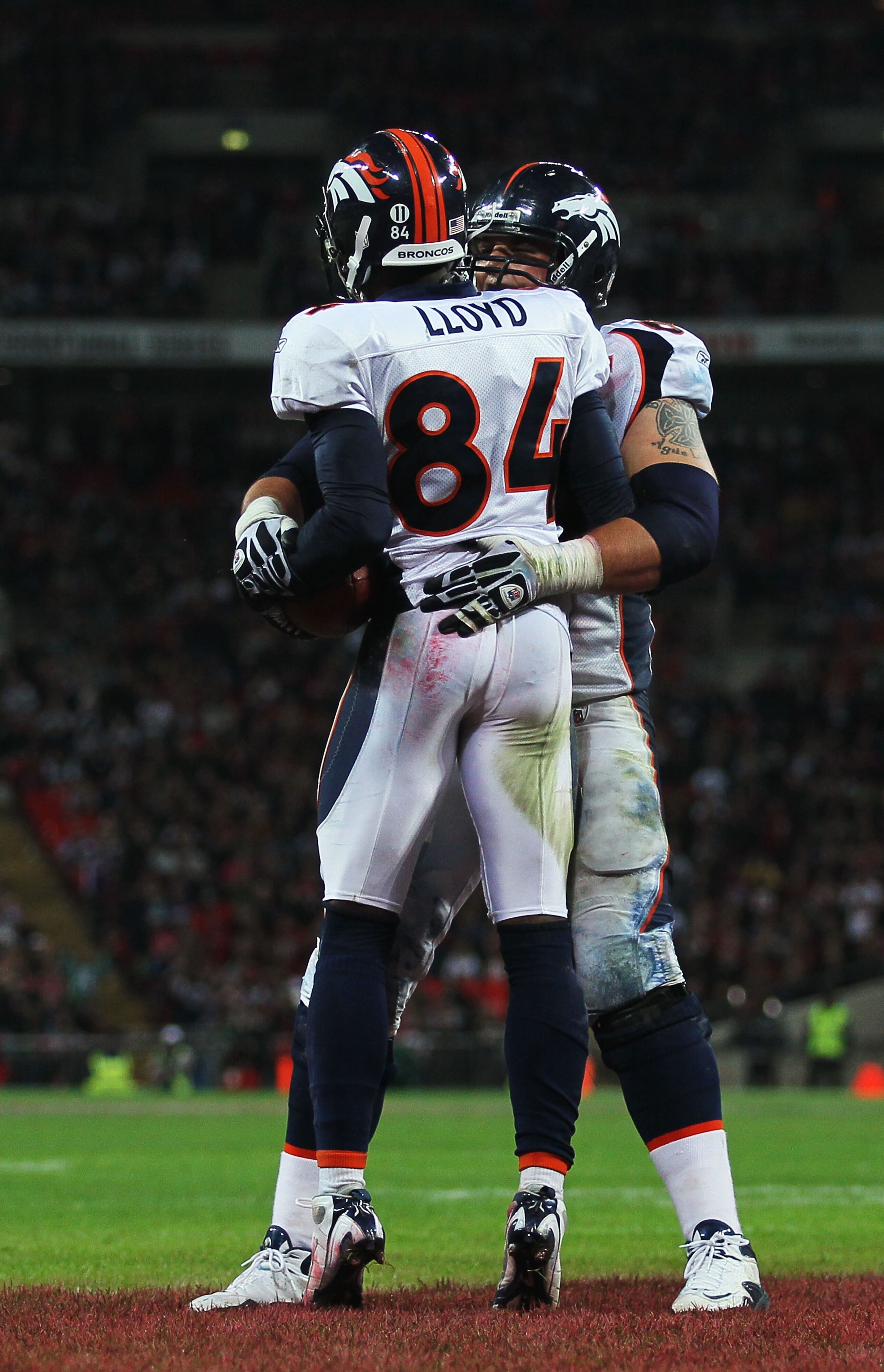 LONDON, ENGLAND - OCTOBER 31:  Brandon Lloyd #84 of Denver Broncos celebrates with Zane Beadles #68 as he scores their second touchdown during the NFL International Series match between Denver Broncos and San Francisco 49ers at Wembley Stadium on October