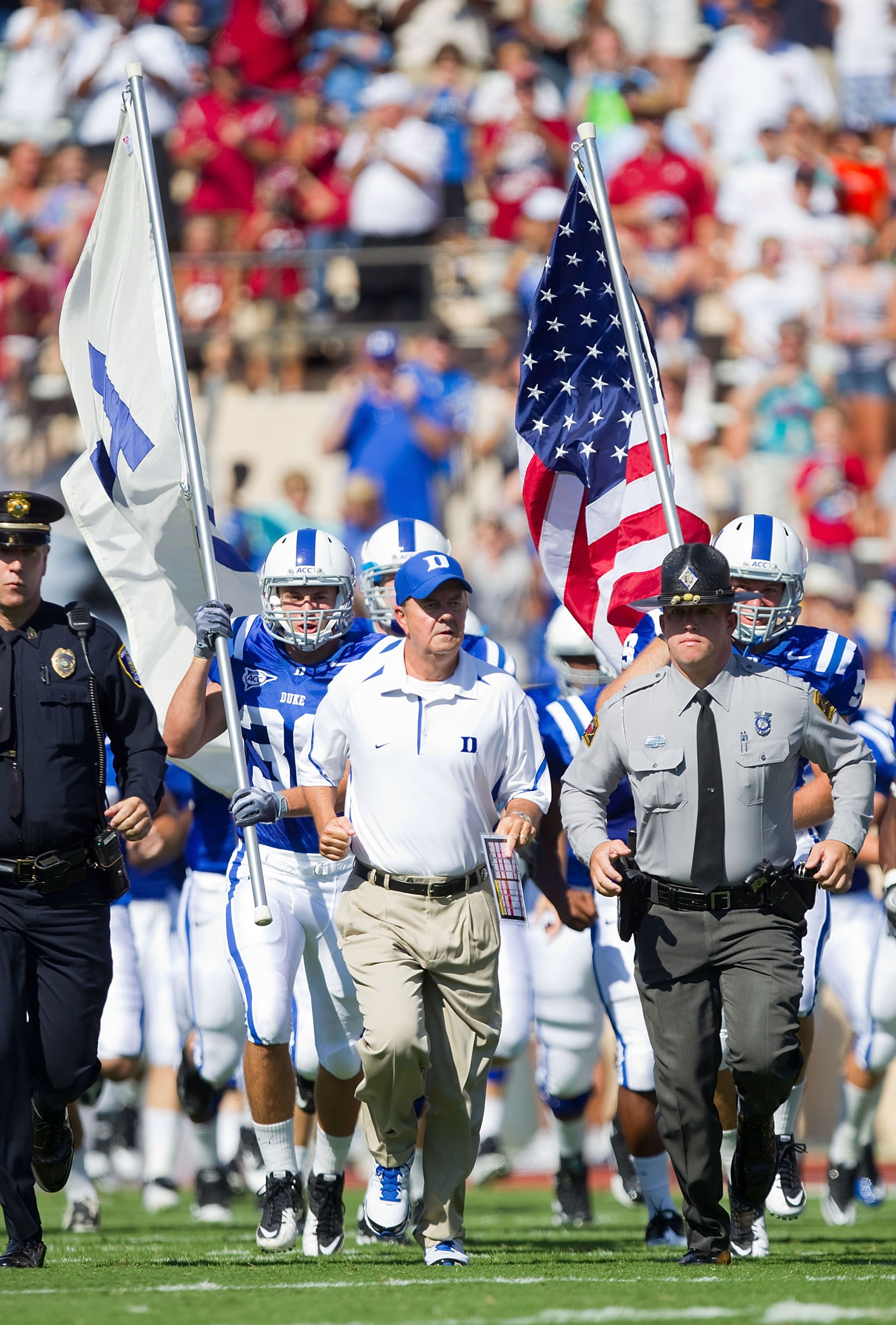 DURHAM, NC - SEPTEMBER 18: Duke Blue Devils head coach David Cutcliffe (C) leads his team on to the field to take on the Alabama Crimson Tide at Wallace Wade Stadium on September 18, 2010 in Durham, North Carolina. The Crimson Tide defeated the Blue Devi DURHAM, NC - SEPTEMBER 18: Duke Blue Devils head coach David Cutcliffe (C) leads his team on to the field to take on the Alabama Crimson Tide at Wallace Wade Stadium on September 18, 2010 in Durham, North Carolina. The Crimson Tide defeated the Blue Devi