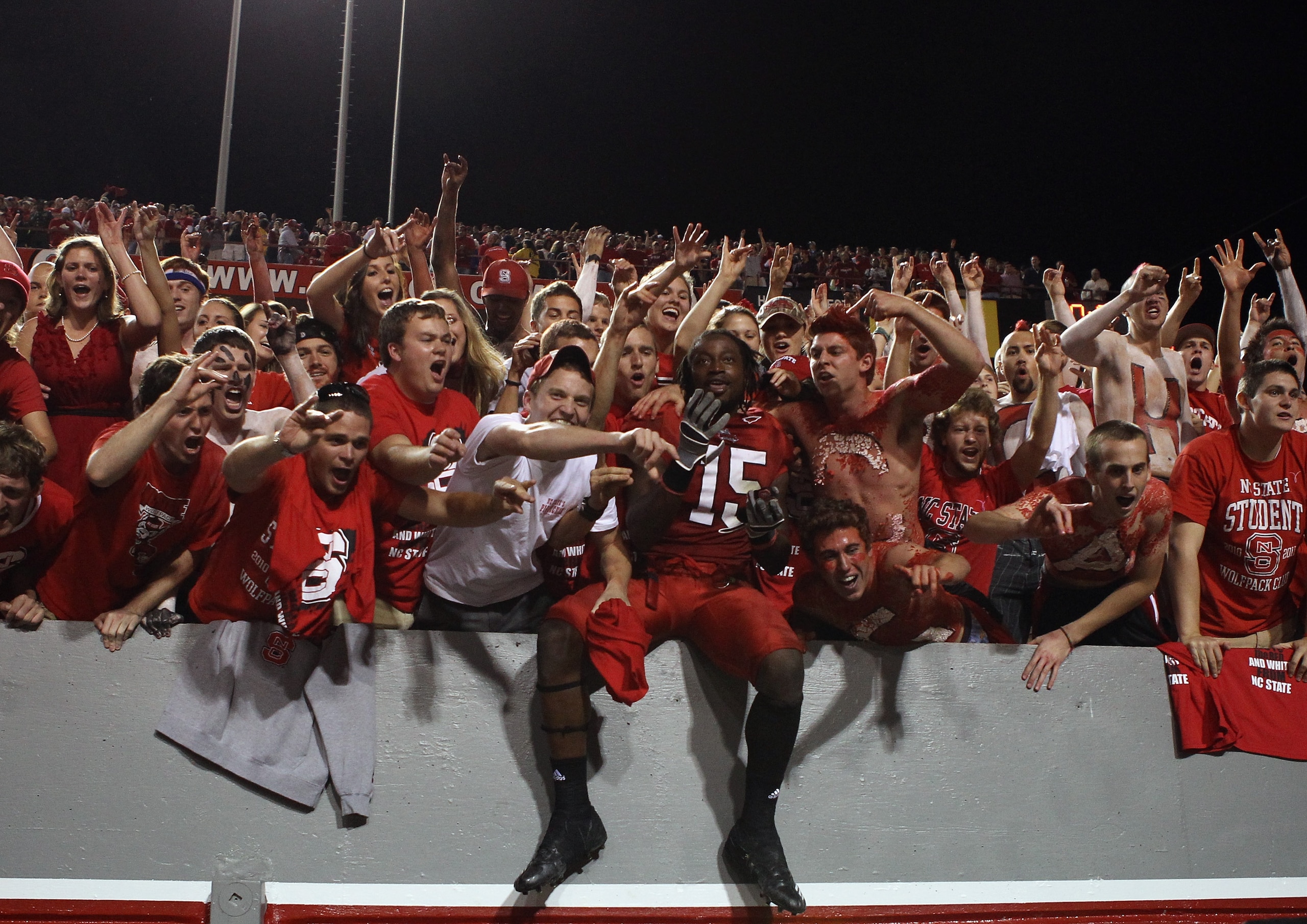 RALEIGH, NC - OCTOBER 28: Darrell Davis #15 of the North Carolina State Wolfpack celebrates with fans after deafeating the Florida State Seminoles 28-24 at Carter-Finley Stadium on October 28, 2010 in Raleigh, North Carolina. (Photo by Streeter Lecka/Ge RALEIGH, NC - OCTOBER 28: Darrell Davis #15 of the North Carolina State Wolfpack celebrates with fans after deafeating the Florida State Seminoles 28-24 at Carter-Finley Stadium on October 28, 2010 in Raleigh, North Carolina. (Photo by Streeter Lecka/Ge