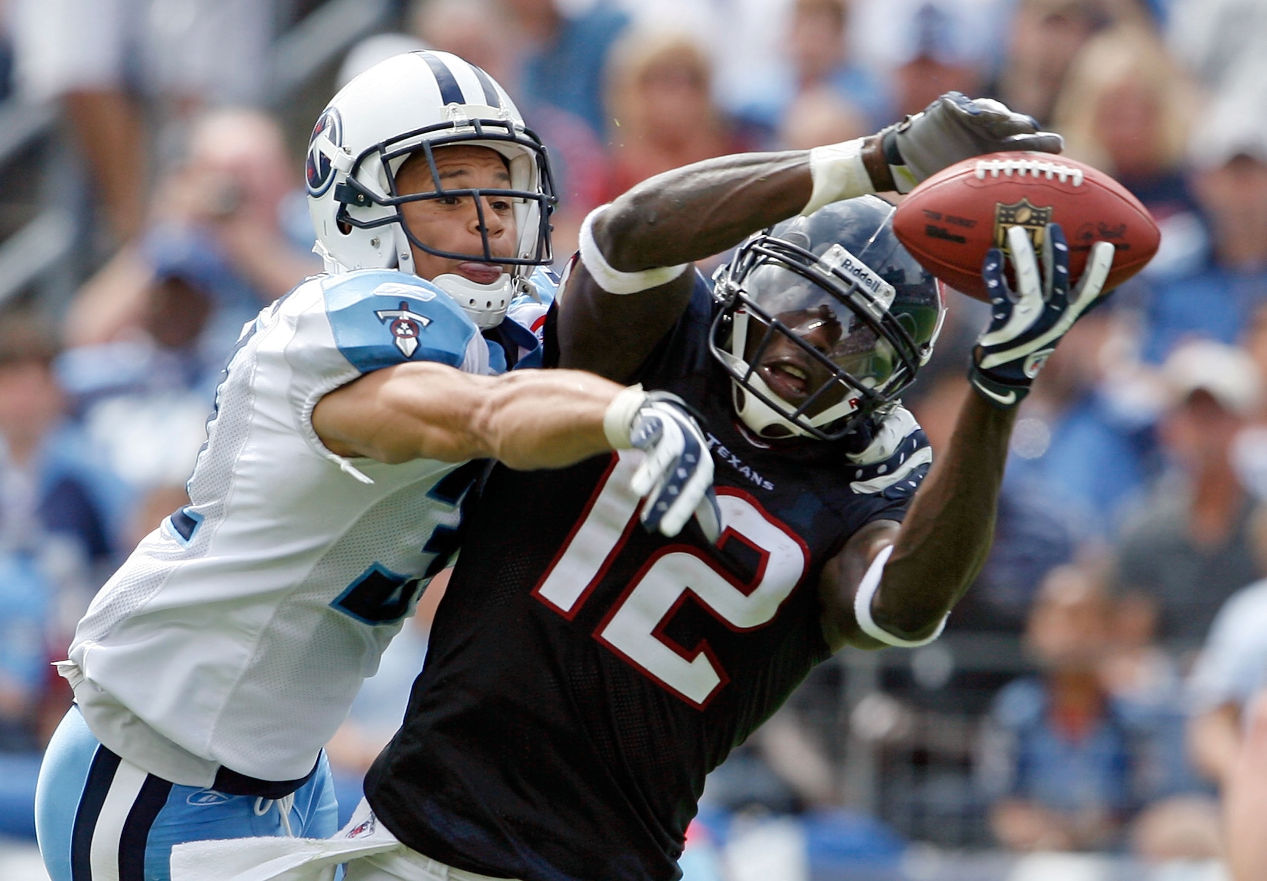 NASHVILLE, TN - SEPTEMBER 20:  Jacoby Jones #12 of the Houston Texans catches a touchdown pass while defended by Cortland Finnegan #31 of the Tennessee Titans during the  NFL game at LP Field on September 20, 2009 in Nashville, Tennessee. The Texans won 3