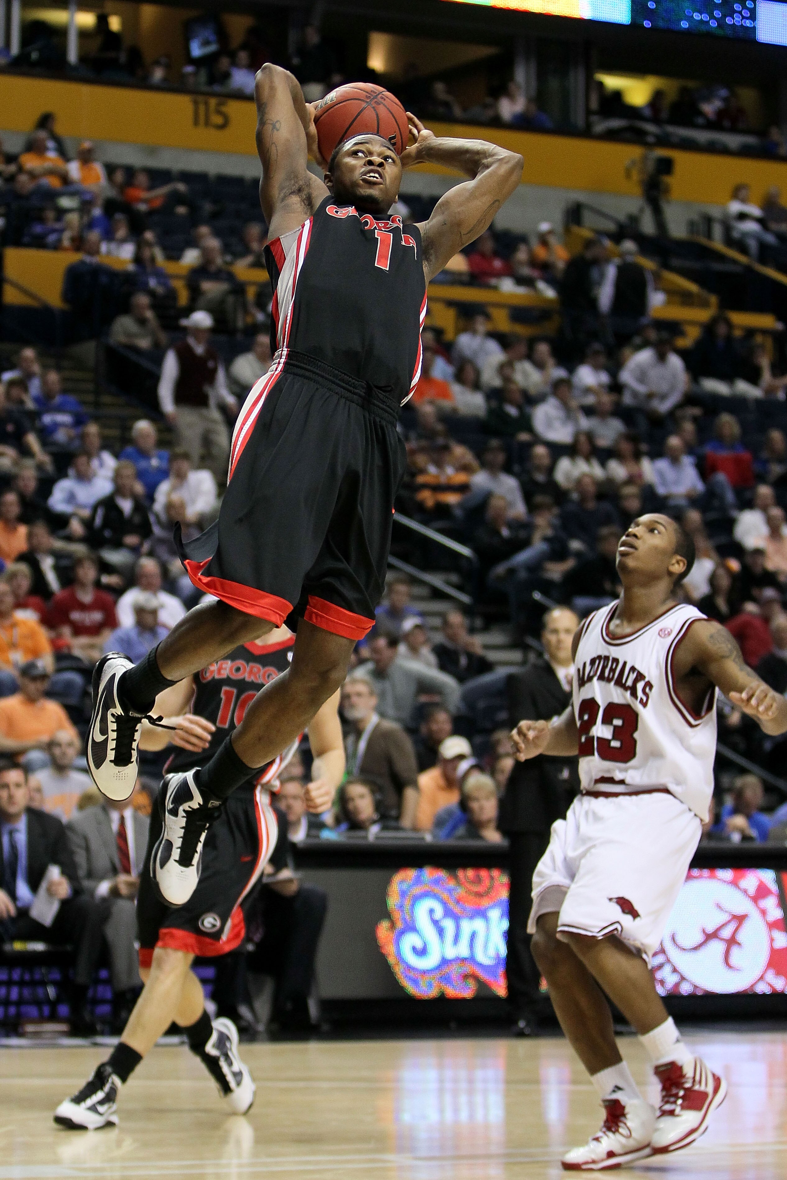 NASHVILLE, TN - MARCH 11:  Travis Leslie #1 of the Georgia Bulldogs goes up for a dunk attempt against Julysses Nobles #23 of the Arkanasas Razorbacks during the first round of the SEC Men's Basketball Tournament at the Bridgestone Arena on March 11, 2010