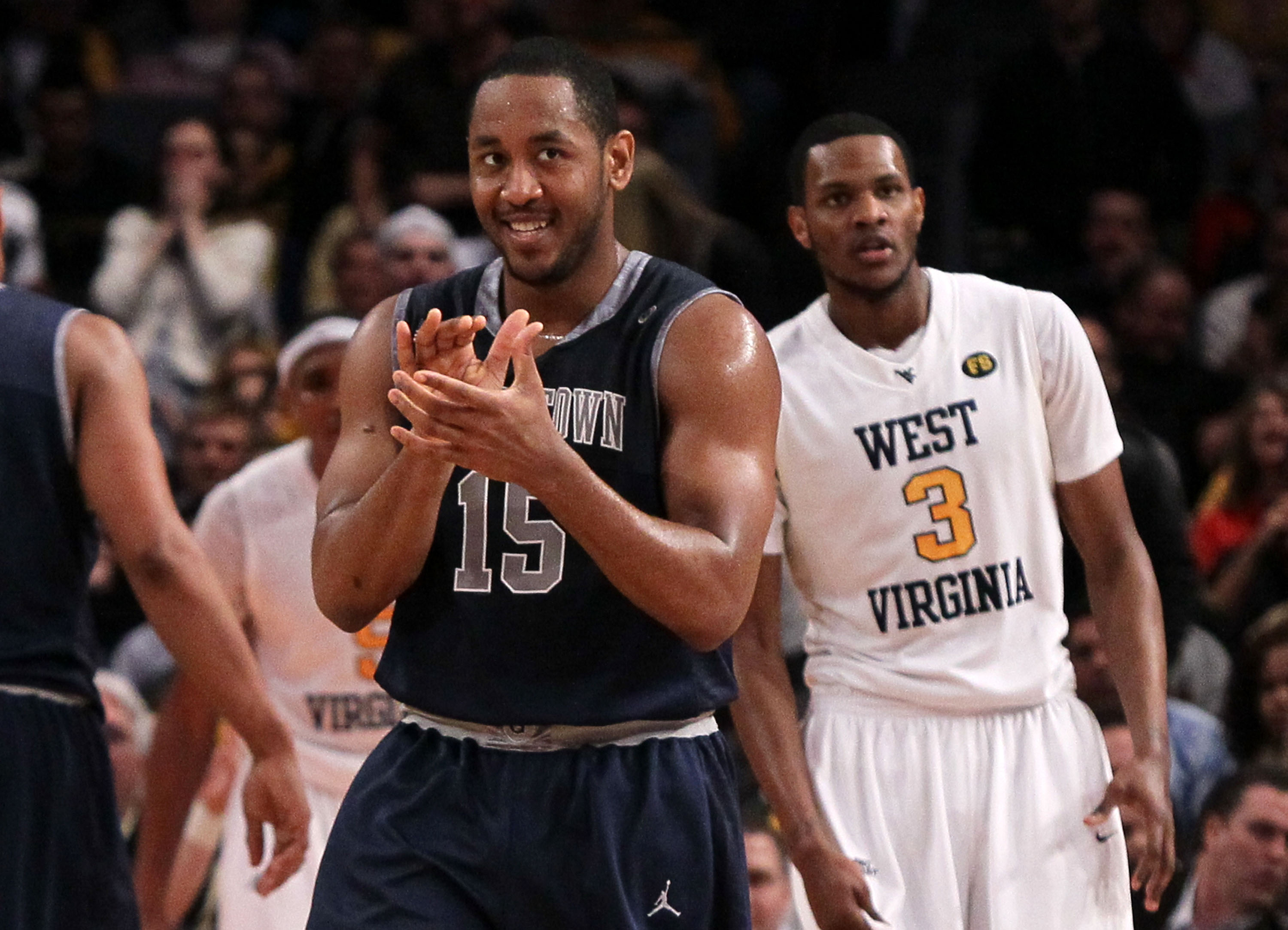 NEW YORK - MARCH 13: Austin Freeman #15 of the Georgetown Hoyas reacts after a play as Devin Ebanks #3 of the West Virginia Mountaineers looks on during the championship of the 2010 NCAA Big East Tournament at Madison Square Garden on March 13, 2010 in Ne