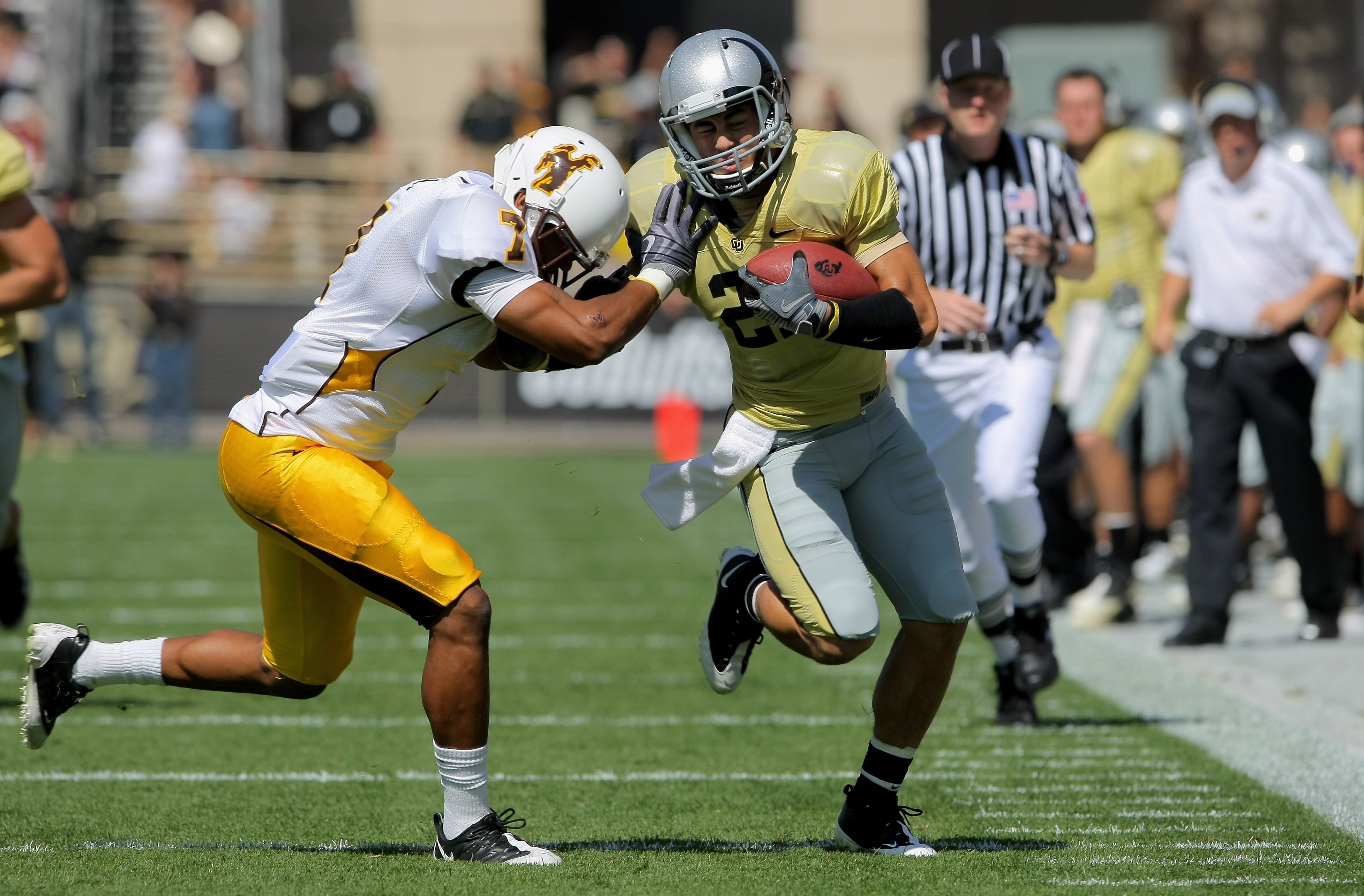 BOULDER, CO - SEPTEMBER 19:  Wide reciever Scotty McKnight #21 of the Colorado Buffaloes makes a reception for a first down before being forced out of bounds by Shamiel Gary #7 of the Wyoming Cowboys at Folsom Field on September 19, 2009 in Boulder, Color