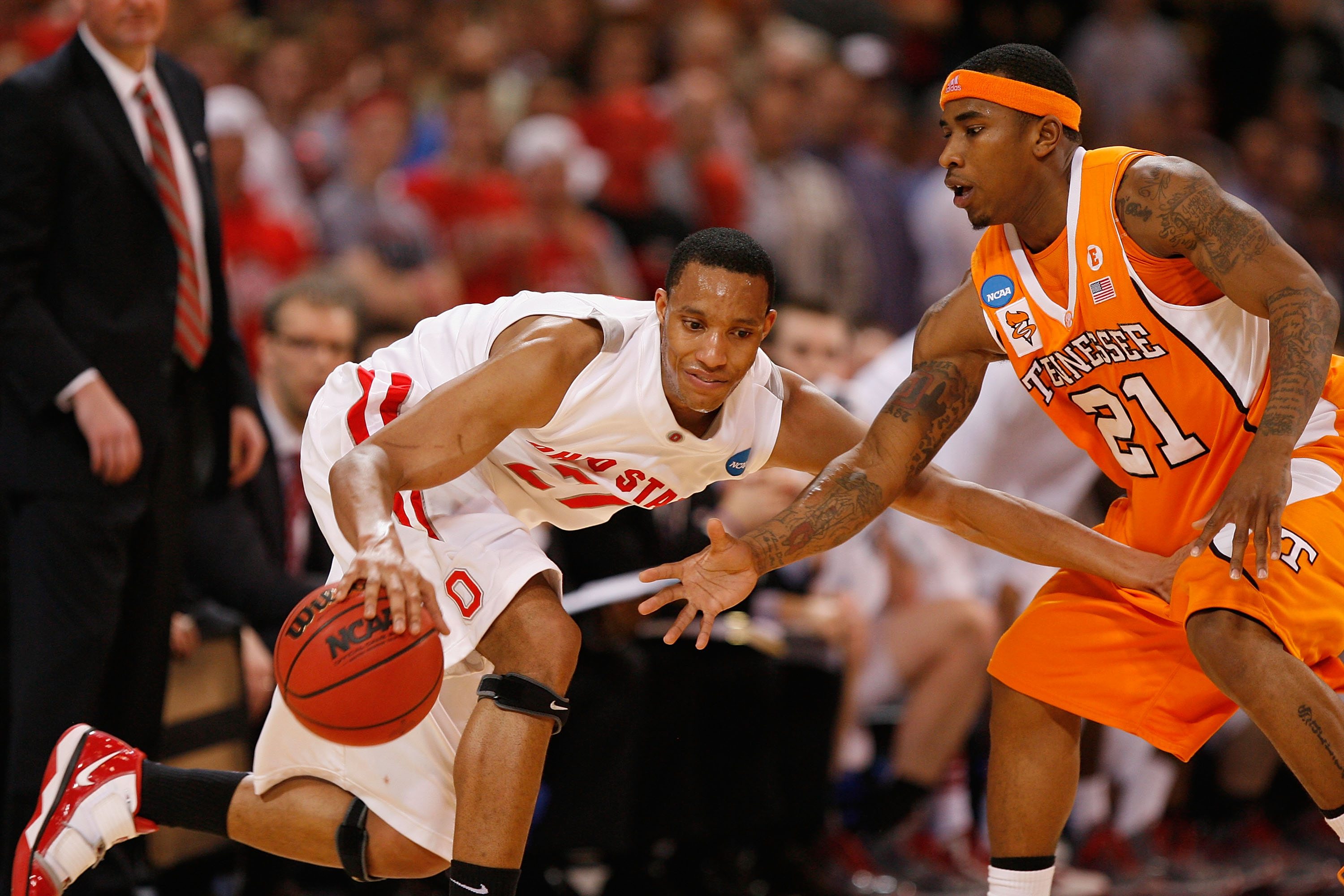 ST. LOUIS - MARCH 26: Evan Turner #21 of the Ohio State  Buckeyes looks to get past Melvin Goins #21 of the Tennessee Volunteers during the midwest regional semifinal of the 2010 NCAA men's basketball tournament at the Edward Jones Dome on March 26, 2010 