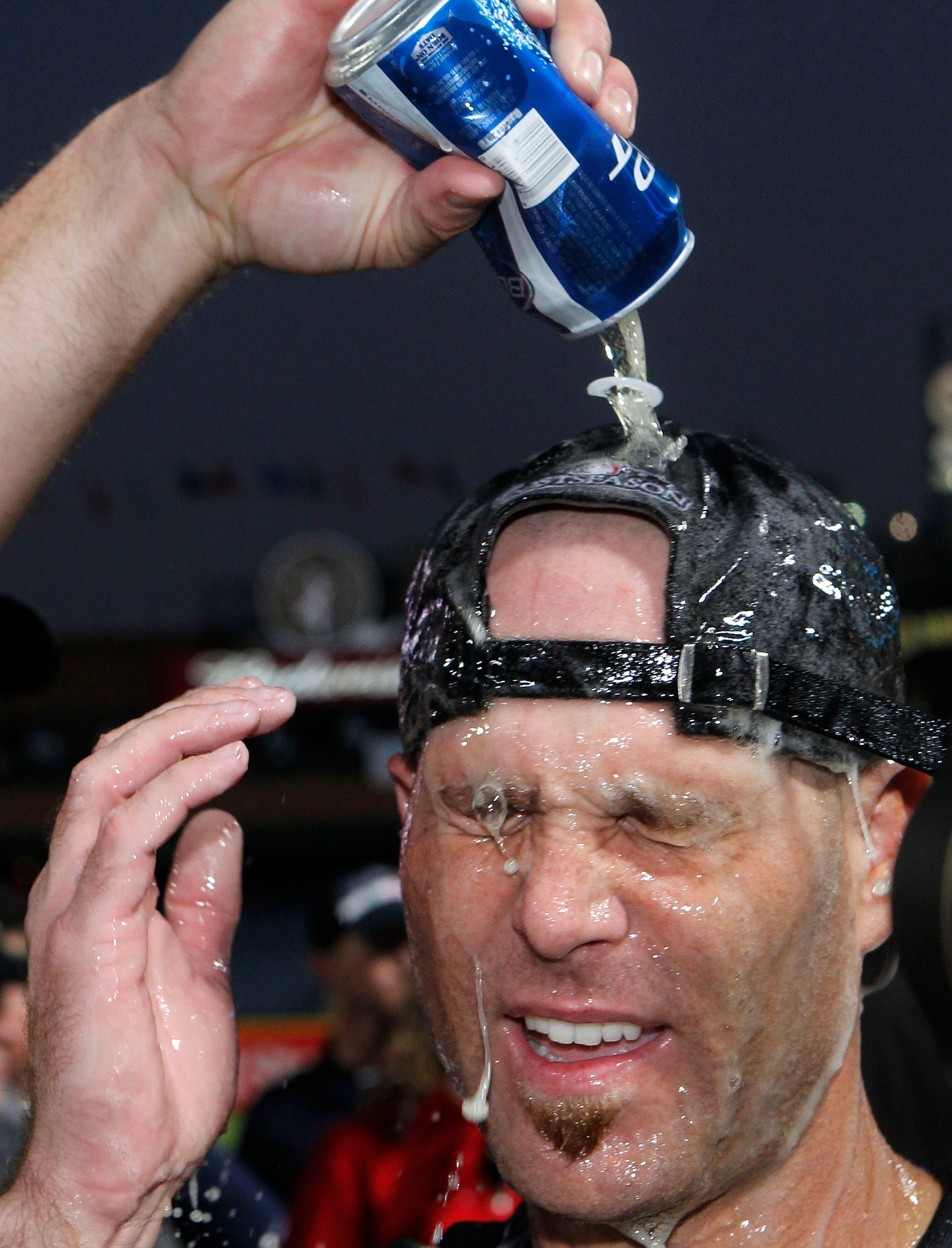 ATLANTA - OCTOBER 03:  Pitcher Tim Hudson #15 of the Atlanta Braves is doused by beer during the on-field playoff celebration after the game against the Philadelphia Phillies at Turner Field on October 3, 2010 in Atlanta, Georgia.  The Braves beat the Phi