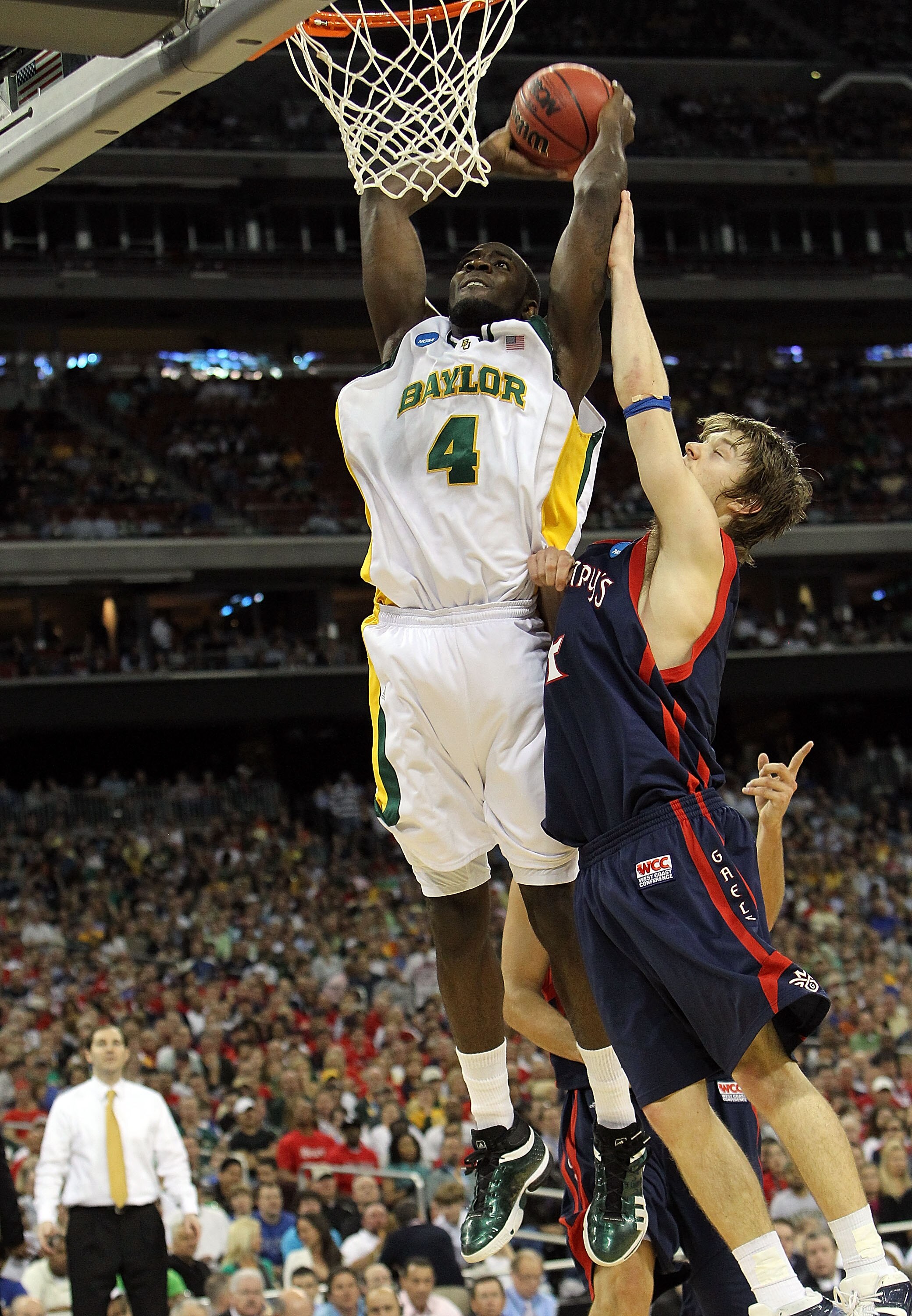 HOUSTON - MARCH 26:  Forward Quincy Acy #4 of the Baylor Bears makes a slam dunk against Matthew Dellavedova #4 of the St. Mary's Gaels during the south regional semifinal of the 2010 NCAA men's basketball tournament at Reliant Stadium on March 26, 2010 i