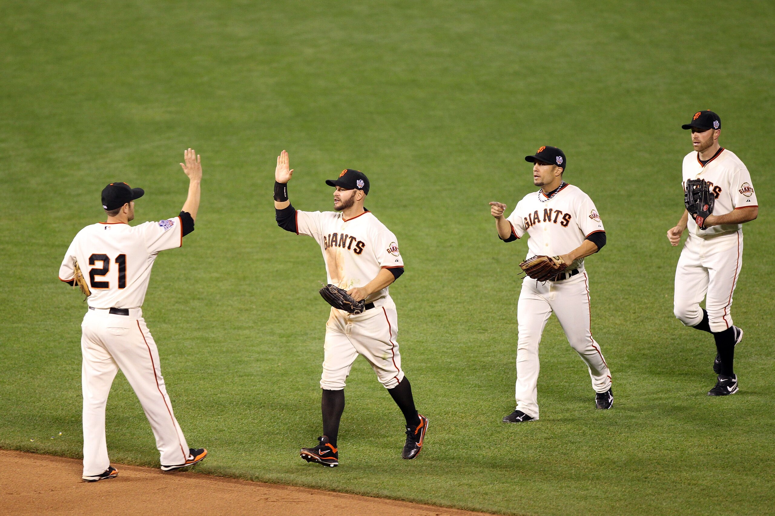 SAN FRANCISCO - OCTOBER 28:  (L-R) Freddy Sanchez #21, Cody Ross #13, Andres Torres #56 and Mike Fontenot #14 of the San Francisco Giants celebrate after the Giants defeated the Texas Rangers 9-0 in Game Two of the 2010 MLB World Series at AT&T Park on Oc