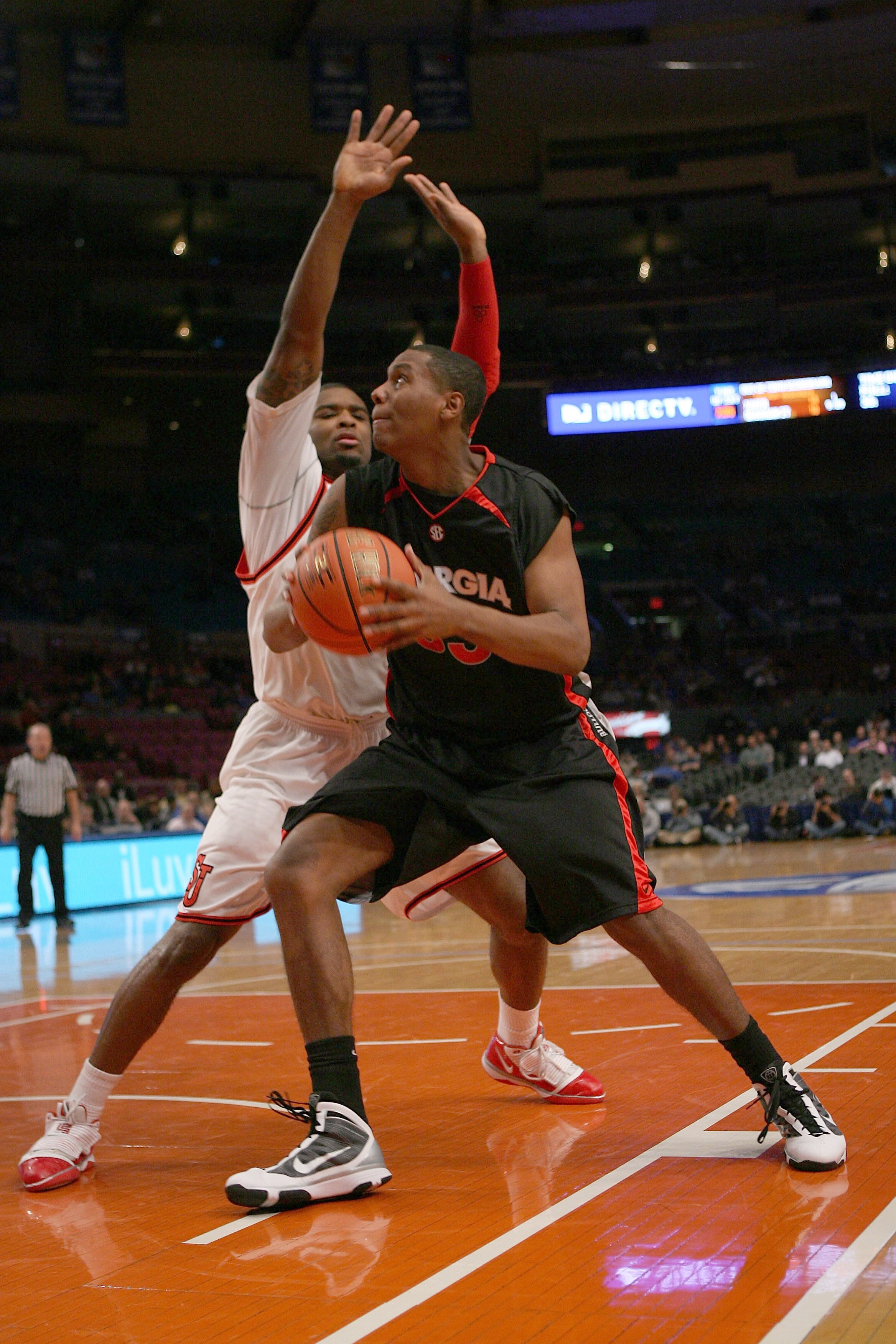 NEW YORK - DECEMBER 09:  Trey Thompkins #33 of the Georgia Bulldogs drives against Sean Evans #5 of the St. John's Red Storm during the SEC Big East Invitational at Madison Square Garden on December 9, 2009 in New York, New York. The Red Storm defeated th