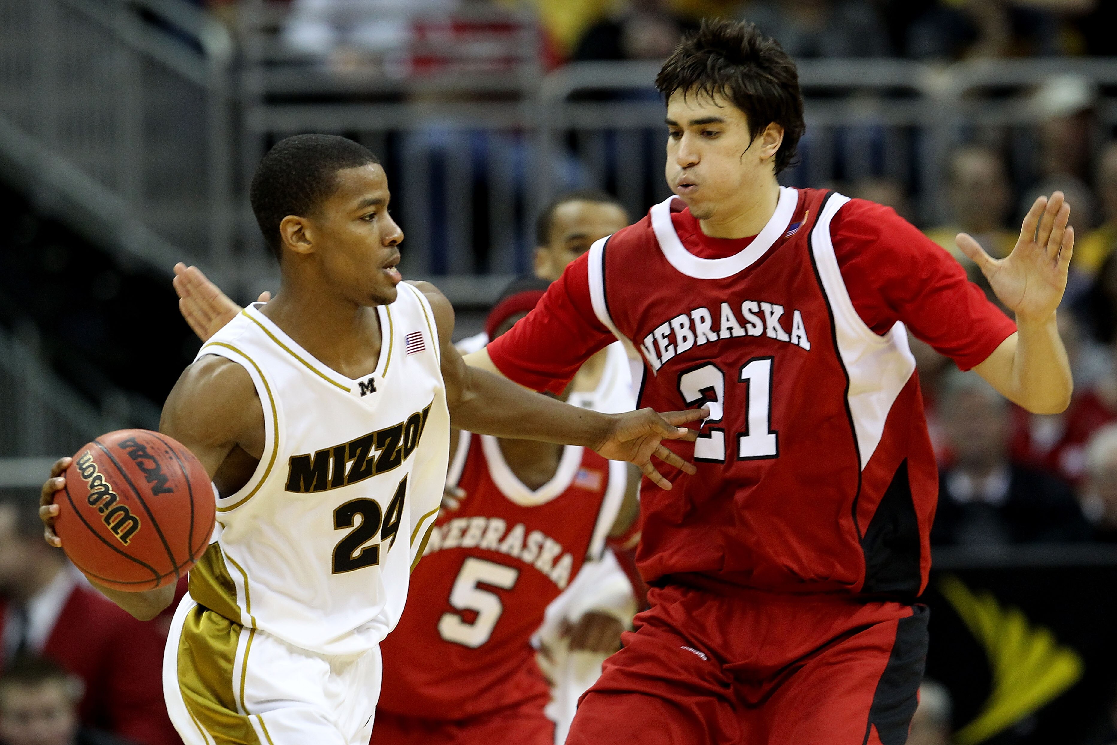 KANSAS CITY, MO - MARCH 10:  Kim English #24 of the Missouri Tigers looks to pass the ball as he is guarded by Jorge Brian Diaz #21 of the Nebraska Cornhuskers in the second half during the first round game of the 2010 Phillips 66 Big 12 Men's Basketball
