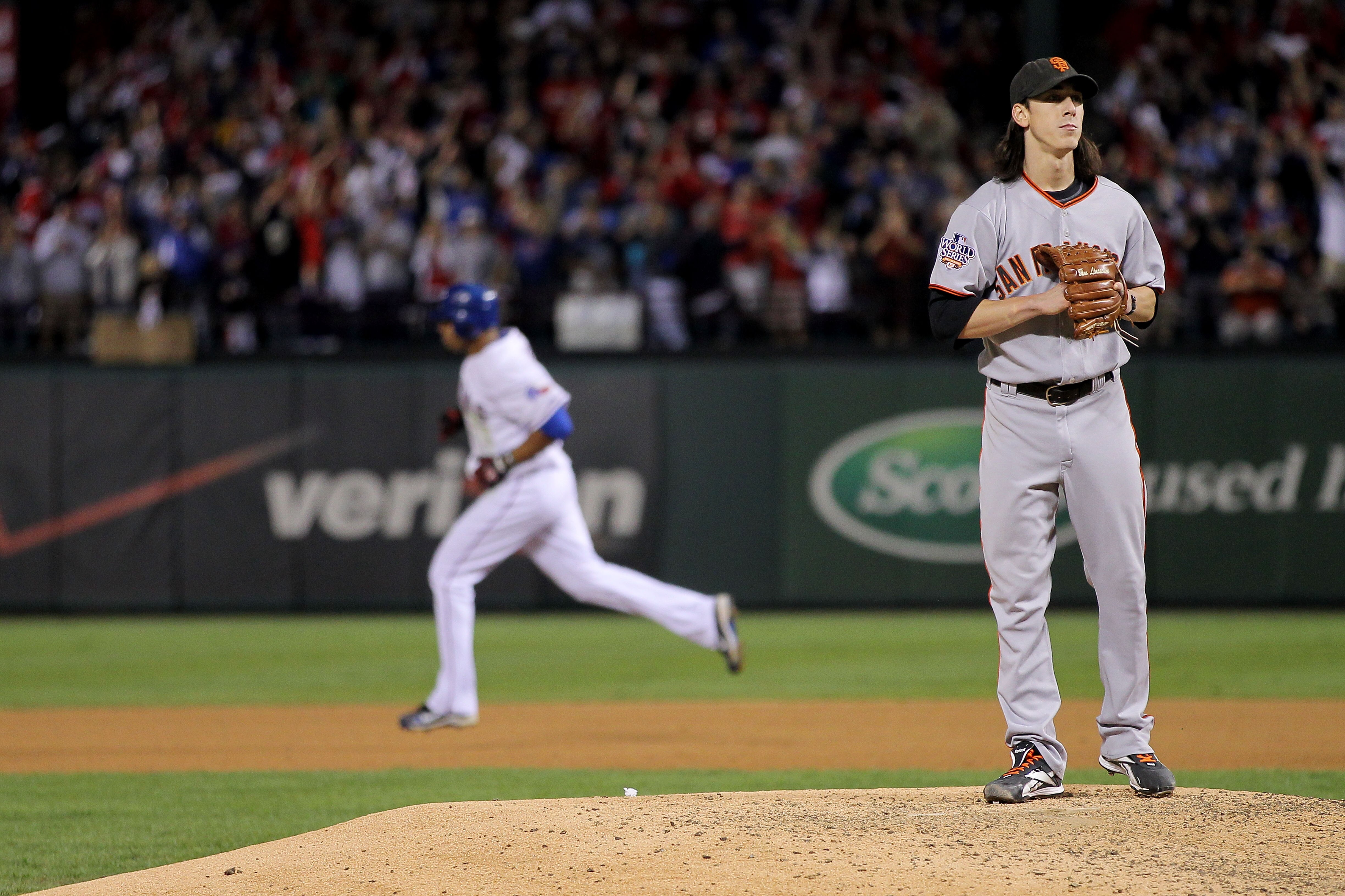 ARLINGTON, TX - NOVEMBER 01:  Starting pitcher Tim Lincecum #55 of the San Francisco Giants looks on as Nelson Cruz #17 of the Texas Rangers rounds the bases on his solo home run in the seventh inning of Game Five of the 2010 MLB World Series at Rangers B