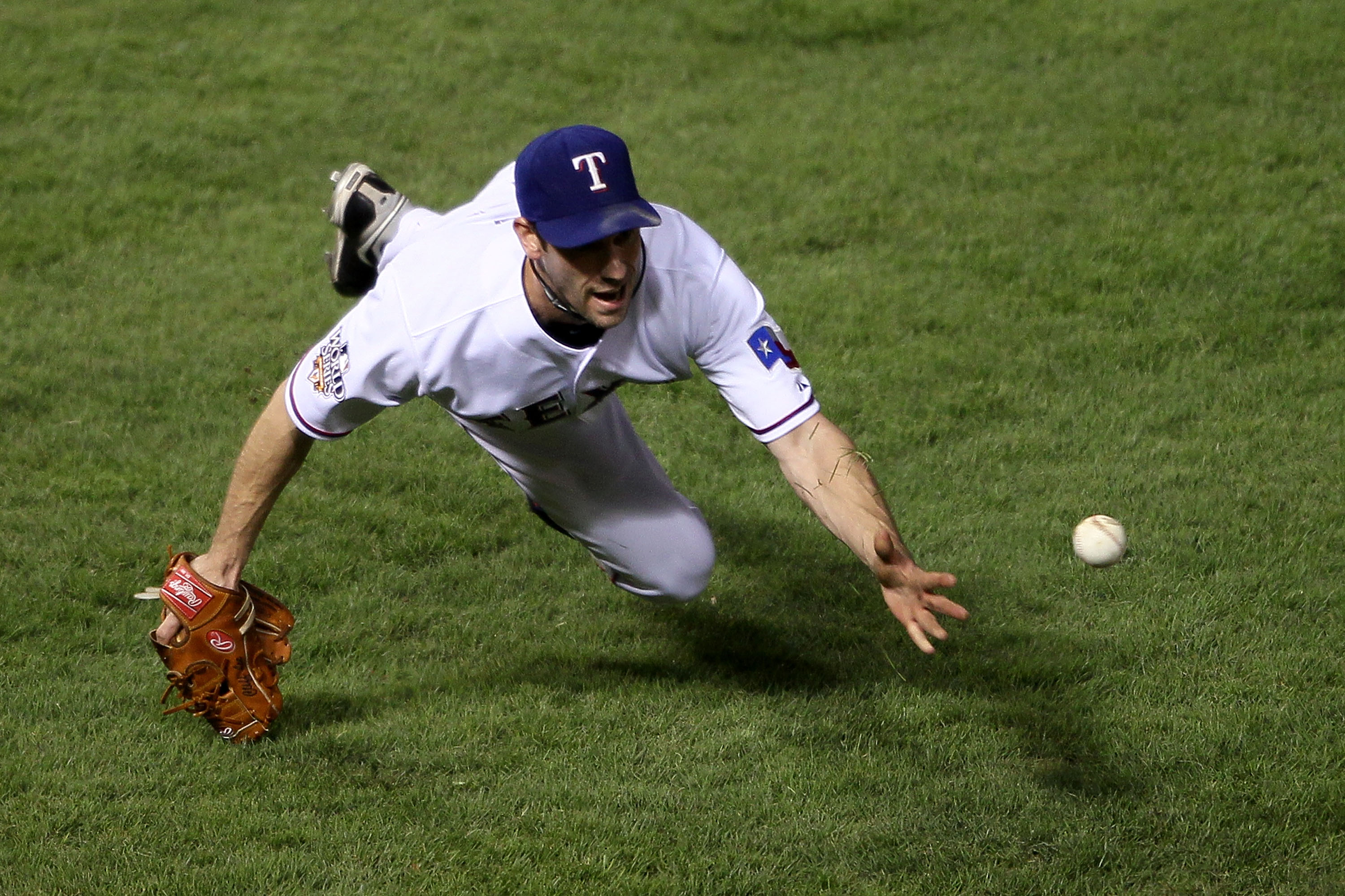 ARLINGTON, TX - NOVEMBER 01:  Cliff Lee #33 of the Texas Rangers tosses over to first for the out after a sac bunt by Aubrey Huff of the San Francisco Giants in Game Five of the 2010 MLB World Series at Rangers Ballpark in Arlington on November 1, 2010 in