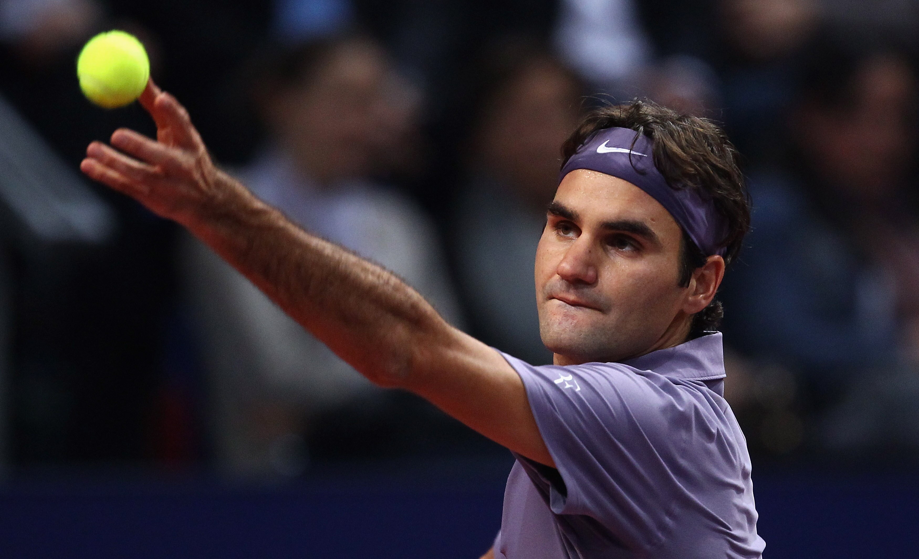 BASEL, SWITZERLAND - NOVEMBER 01:  Roger Federer of Switzerland serves to Alexandr Dolgopolov of Ukraine during Day One of the Davidoff Swiss Indoors Tennis at St Jakobshalle on November 1, 2010 in Basel, Switzerland.  (Photo by Julian Finney/Getty Images