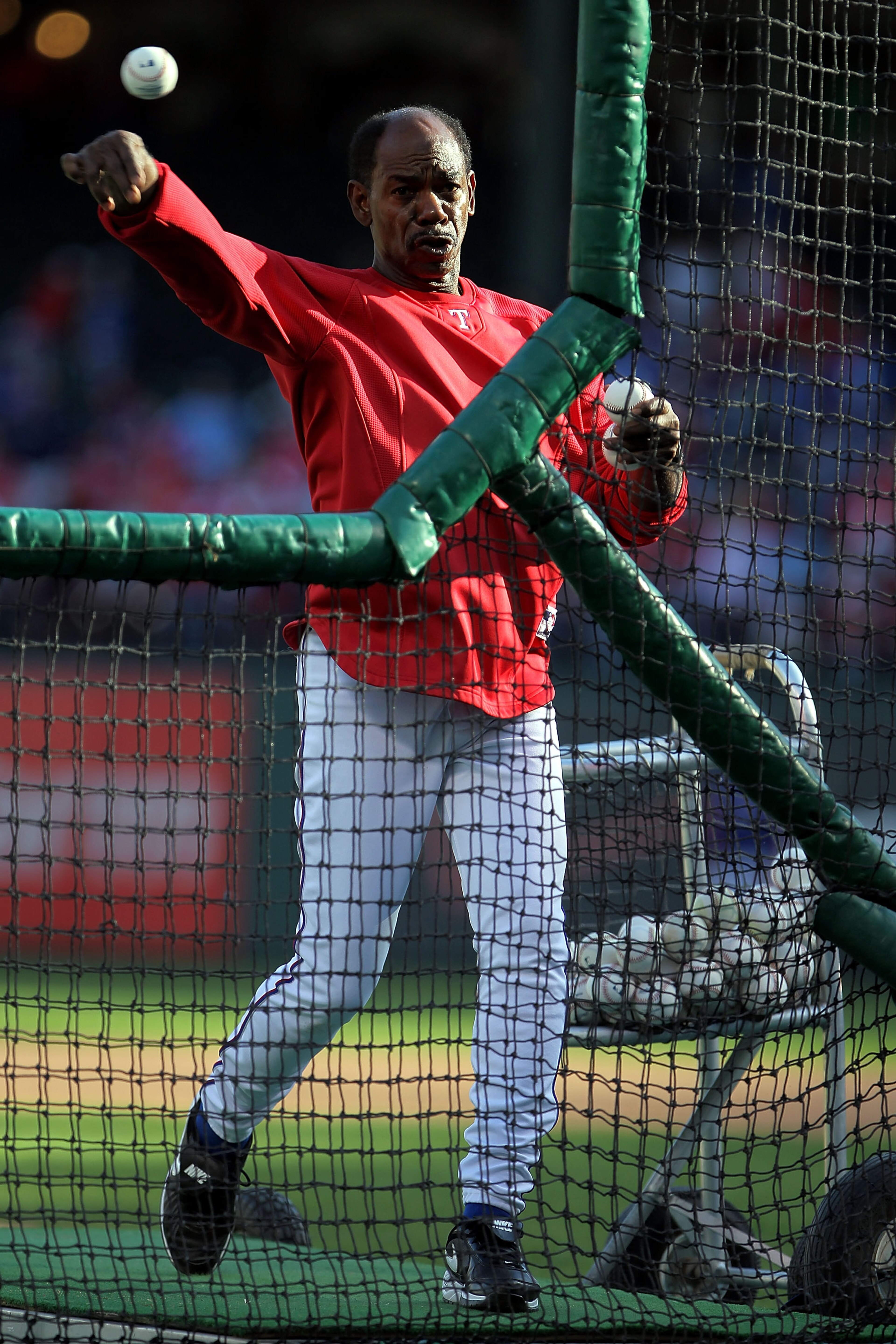ARLINGTON, TX - NOVEMBER 01:  Manager Ron Washington of the Texas Rangers pitches batting practice to his players prior to playing against the San Francisco Giants in Game Five of the 2010 MLB World Series at Rangers Ballpark in Arlington on November 1, 2