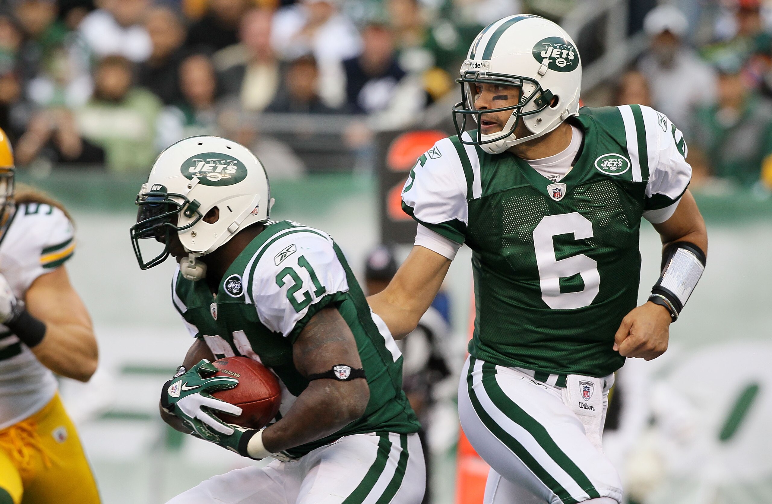 EAST RUTHERFORD, NJ - OCTOBER 31: Mark Sanchez #6 of the New York Jets hands the ball to teammate LaDainian Tomlinson #21 against the Green Bay Packers on October 31, 2010 at the New Meadowlands Stadium in East Rutherford, New Jersey. The Packers defeated