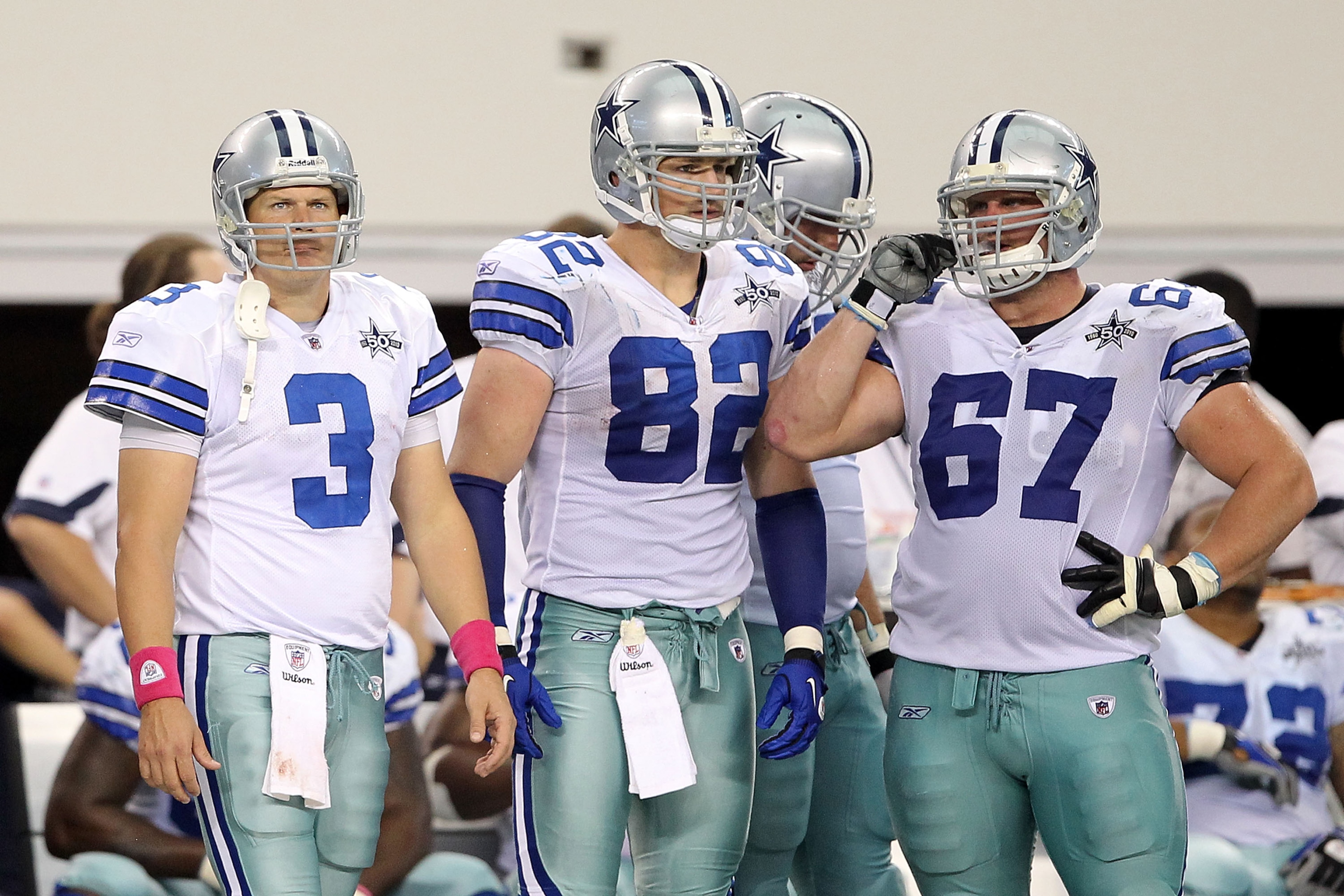 ARLINGTON, TX - OCTOBER 31:  (L-R) Jon Kitna #3, Jason Witten #82 and Phil Costa #67 of the Dallas Cowboys look on from the sideline late in the fourth quarter against the Jacksonville Jaguars at Cowboys Stadium on October 31, 2010 in Arlington, Texas.  (