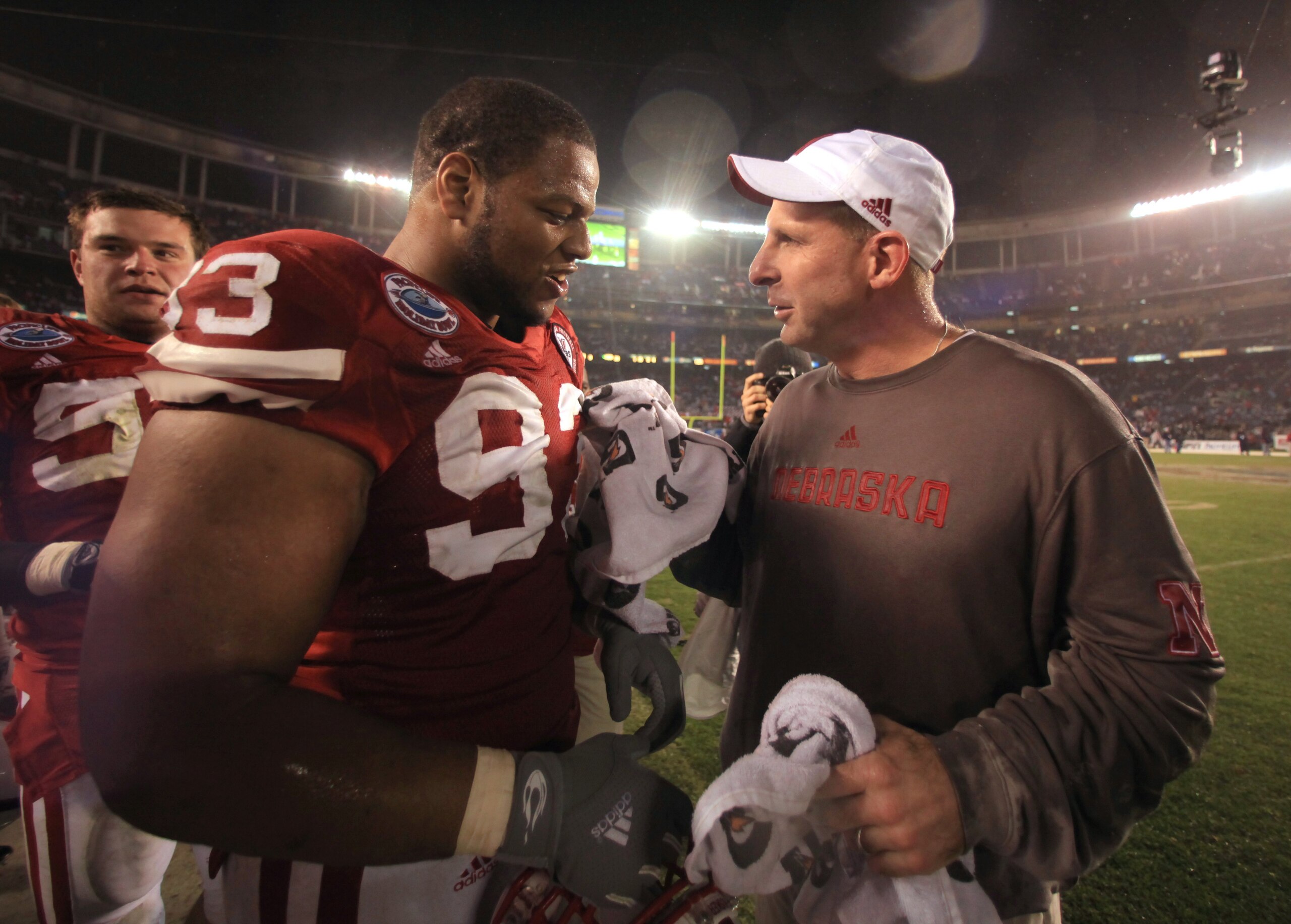 SAN DIEGO - DECEMBER 30:  Ndamukong Suh #93 talks with Head Coach Bo Pelini of the University of Nebraska Cornhuskers after their team's 33-0 victory against the University of Arizona Wildcats during the Pacific Life Holiday Bowl, on December 30, 2009 at 