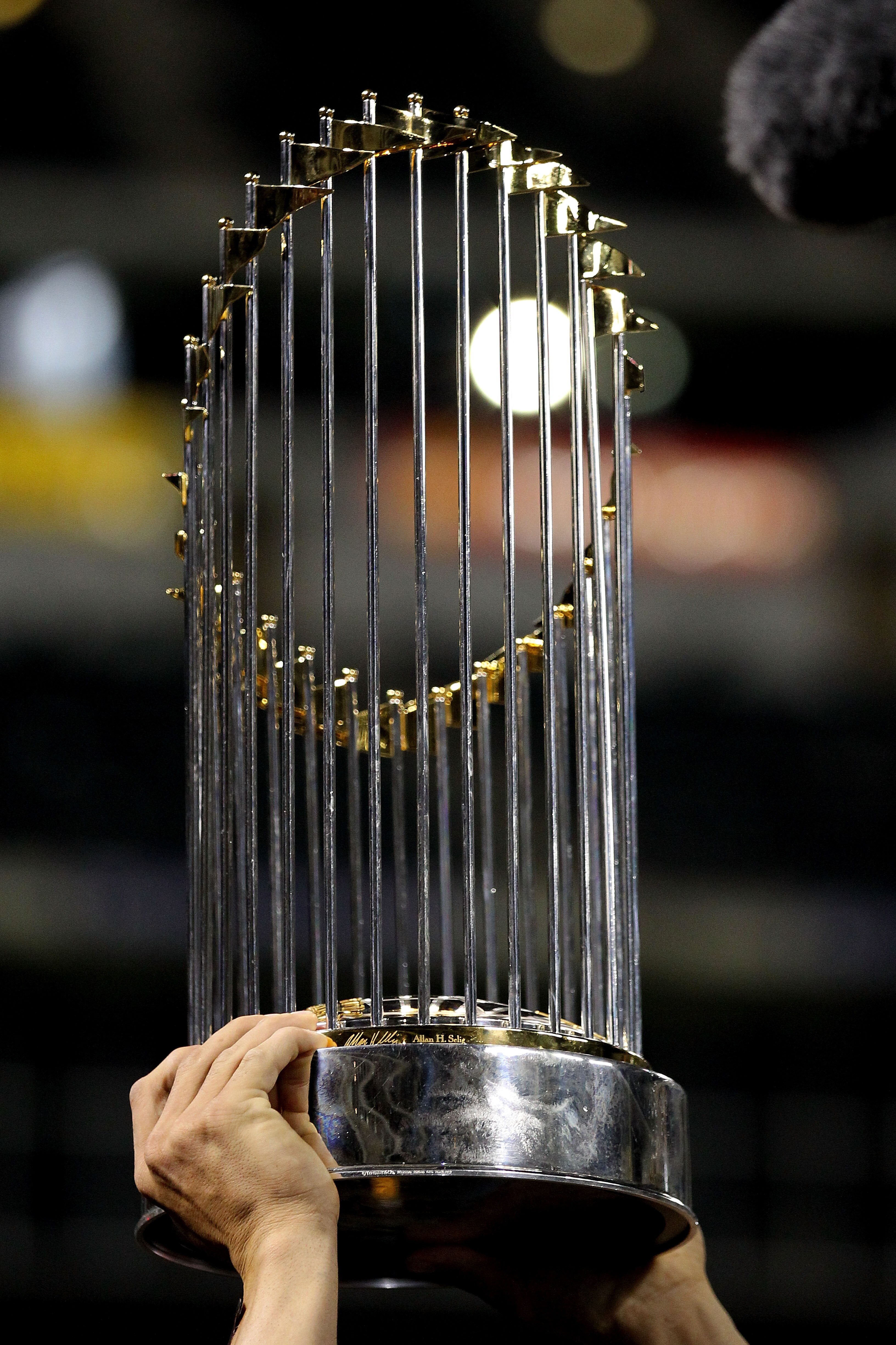 ARLINGTON, TX - NOVEMBER 01:  A detail of a player from the San Francisco Giants celebrating with the World Series Championship trophy after they won 3-1 against the Texas Rangers in Game Five of the 2010 MLB World Series at Rangers Ballpark in Arlington